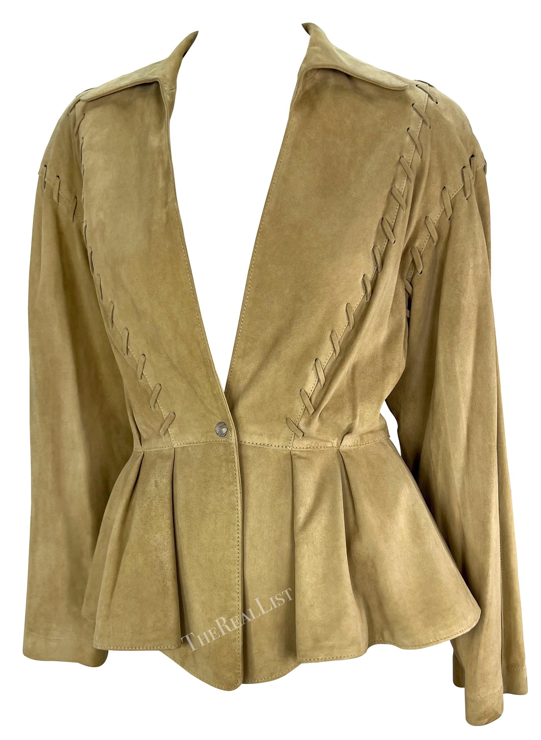 This stunning tan suede jacket by Thierry Mugler is a standout piece from 1990s. Crafted entirely from light tan suede, the jacket features a single snap button closure at the front, a plunging neckline, and a fold-over collar for added elegance.