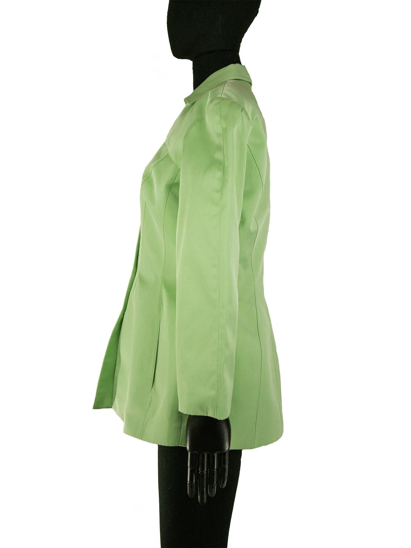 A 1990s Thierry Mugler jacket in a tea green midweight fabric, giving it the support it needs to uphold its structure. The front displays some beautiful tailoring, curved princess seams giving the wearer an exaggerated silhouette. The jacket also