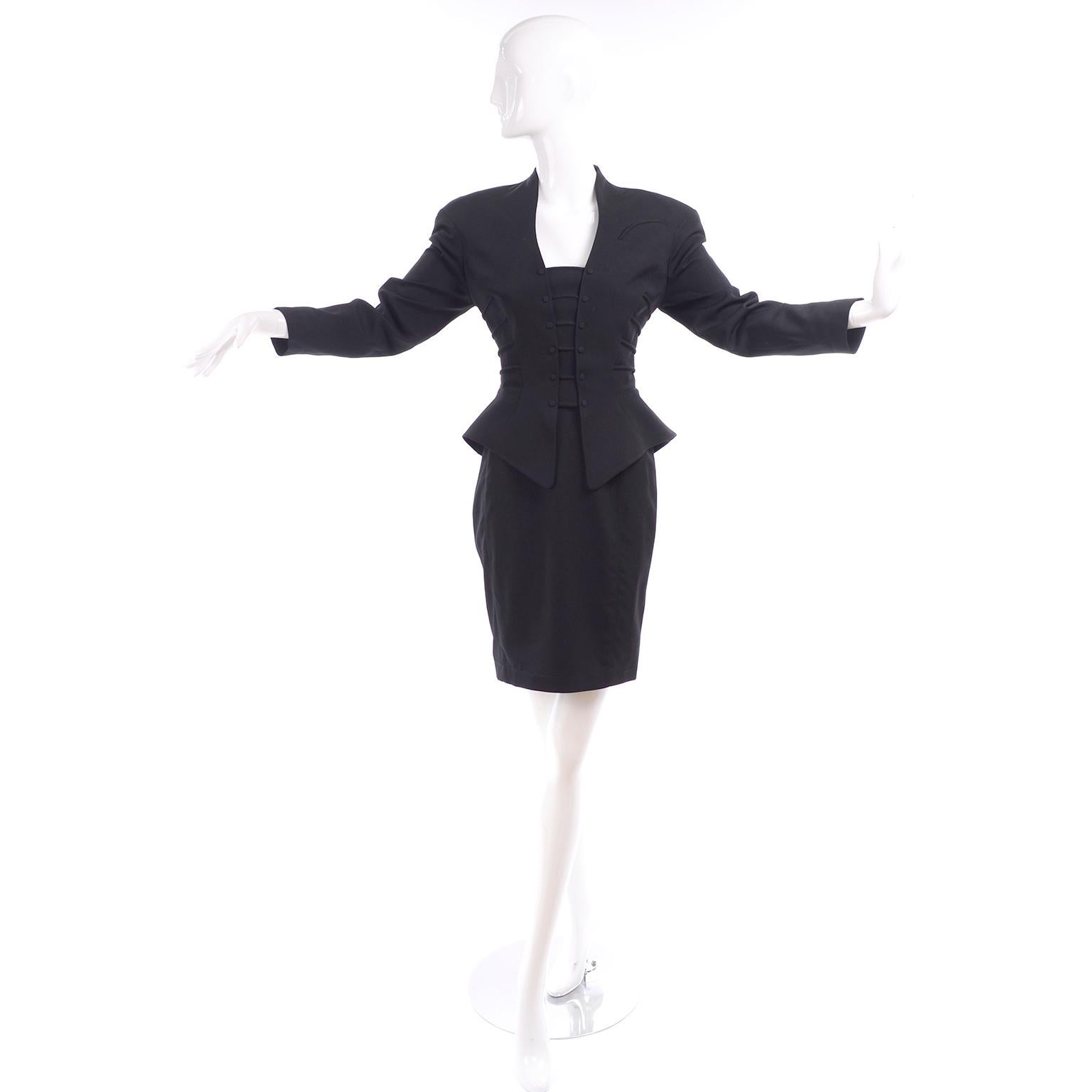 1990's vintage Thierry Mugler black combed wool skirt suit with a dramatic peplum jacket and pencil skirt. The jacket has thick horizontal 