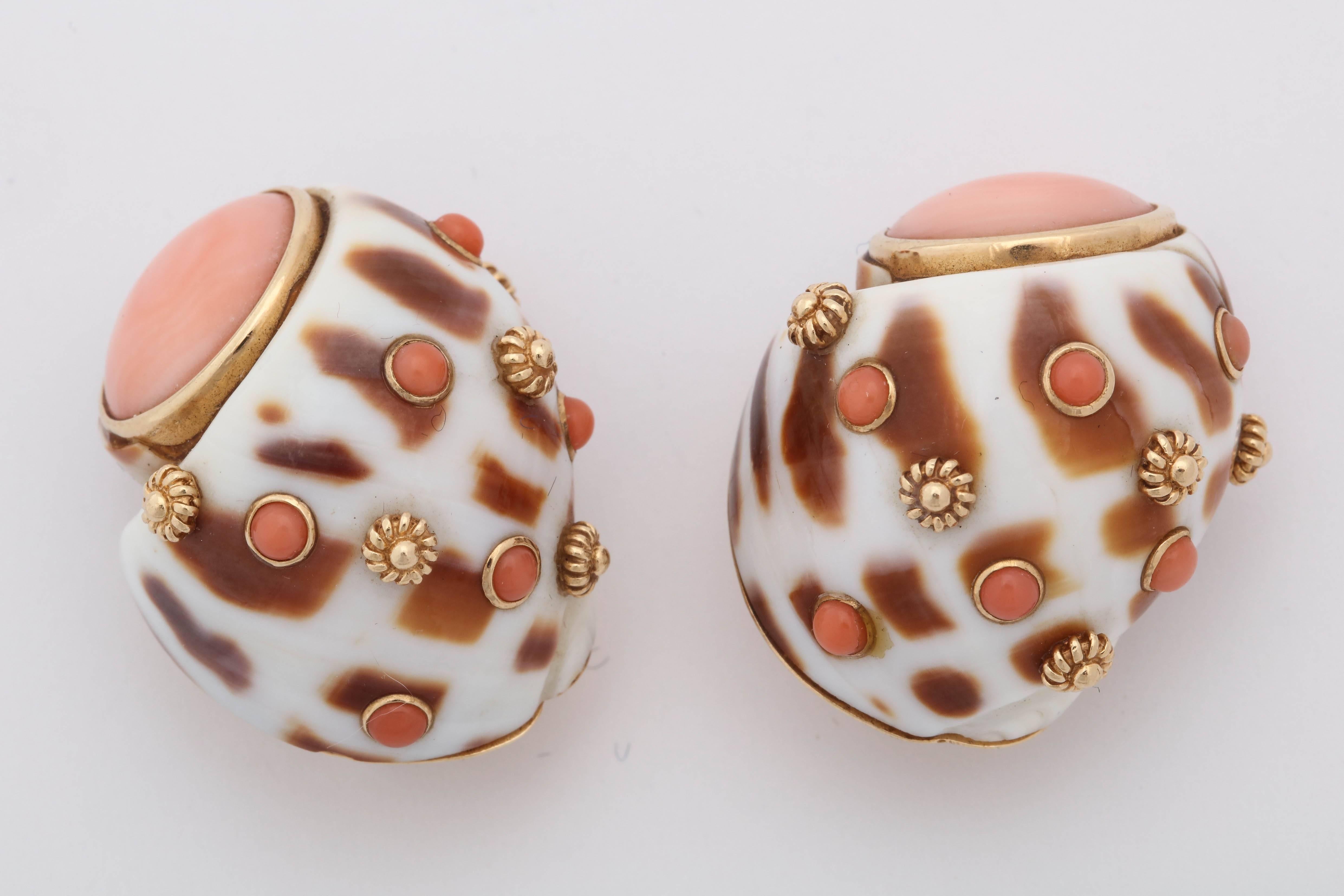 One Pair Of Ladies 14kt Yellow Gold Earclips Designed With An Animal Print Shell Motif. Earrings Are Further Embellished With Two Bezel Set Angel Skin Coral stones Measuring approximately 13MM Each Stone. These Great Earclips Are Further Created