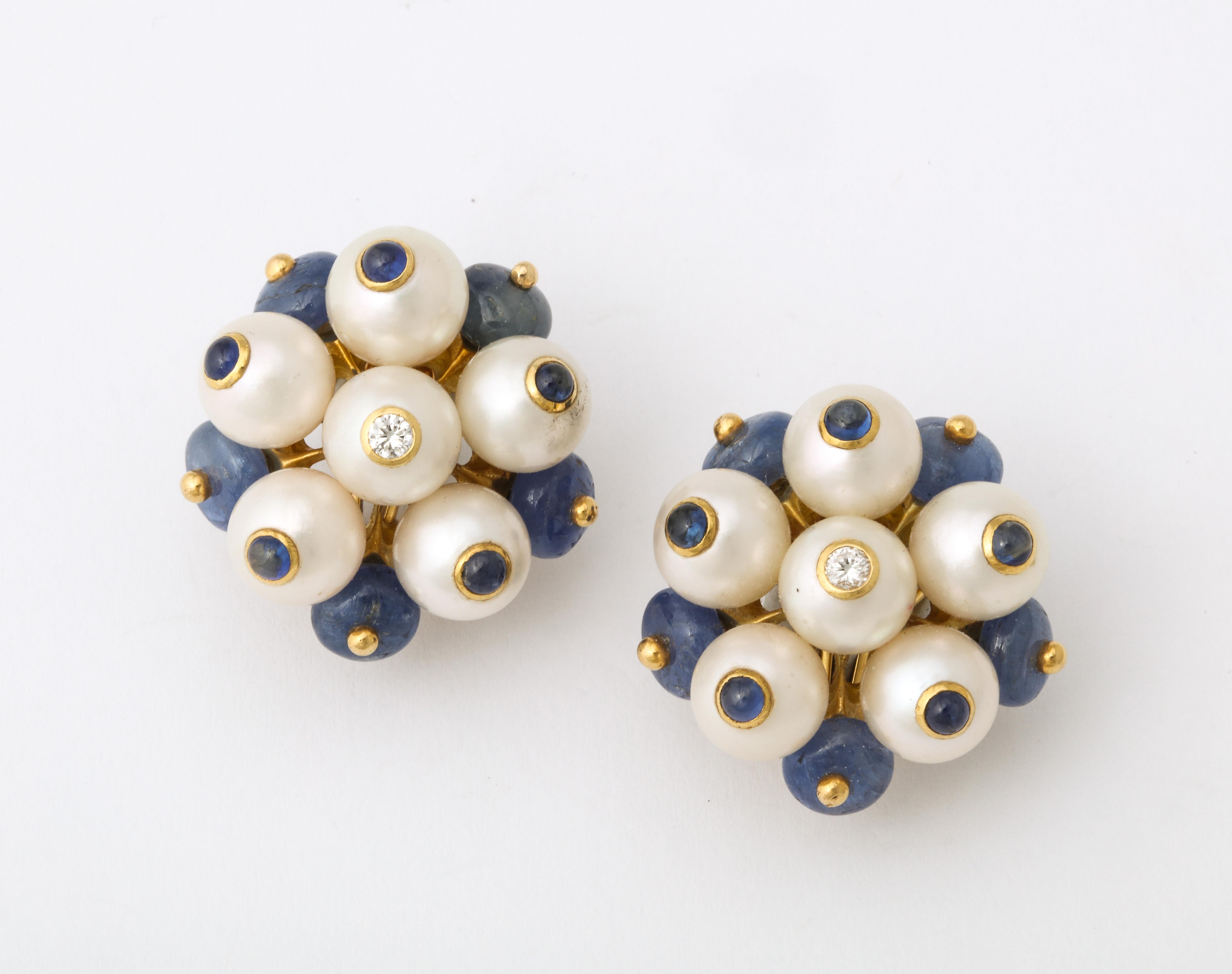One Pair Of Ladies Clip On Earrings Embelished With Numerous Cabochon Sapphires And Designed With Pearls In A Cluster Style. These Earrings Are Signed Trianon In Which Seaman Schepps Now Owns This Jewelry Company.. Circa 1990's.