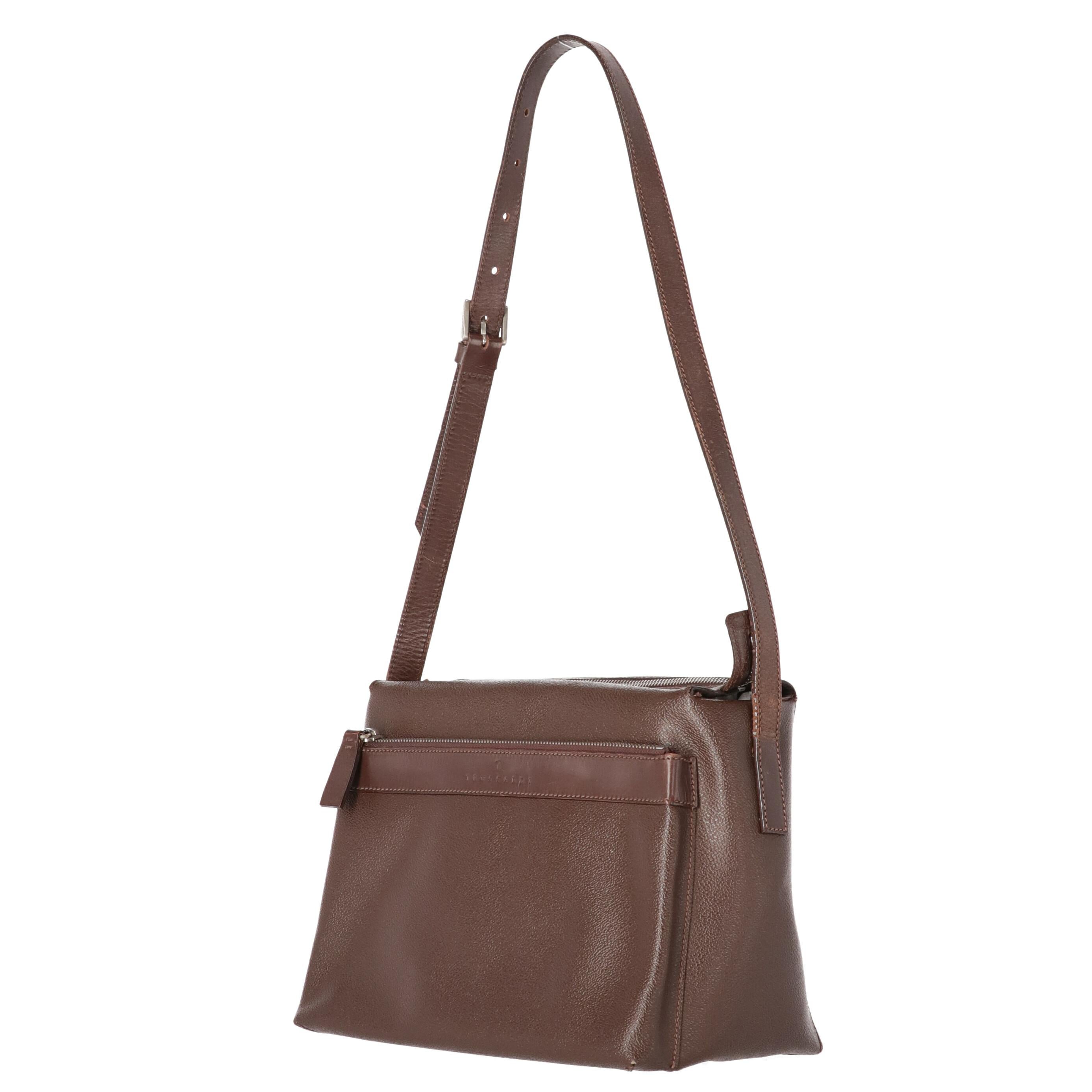 Crespo Collection Trussardi brown textured genuine leather shoulder bag, trapeze design and zip closure. Tone-on-tone smooth leather adjustable shoulder strap with logoed metal buckle. It features a wide front pocket with smooth leather insert,