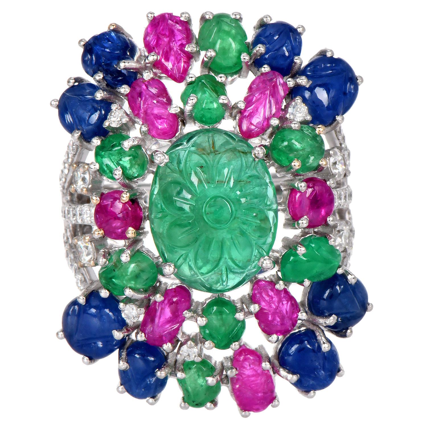 1990's Tutti Frutti Gemstone Diamond Cocktail Ring, an extraordinary display of artistry and luxury.

This wide, floral-inspired ring is centered with a stunning 5.50-carat carved flower oval cabochon emerald, surrounded by a garden of intricately