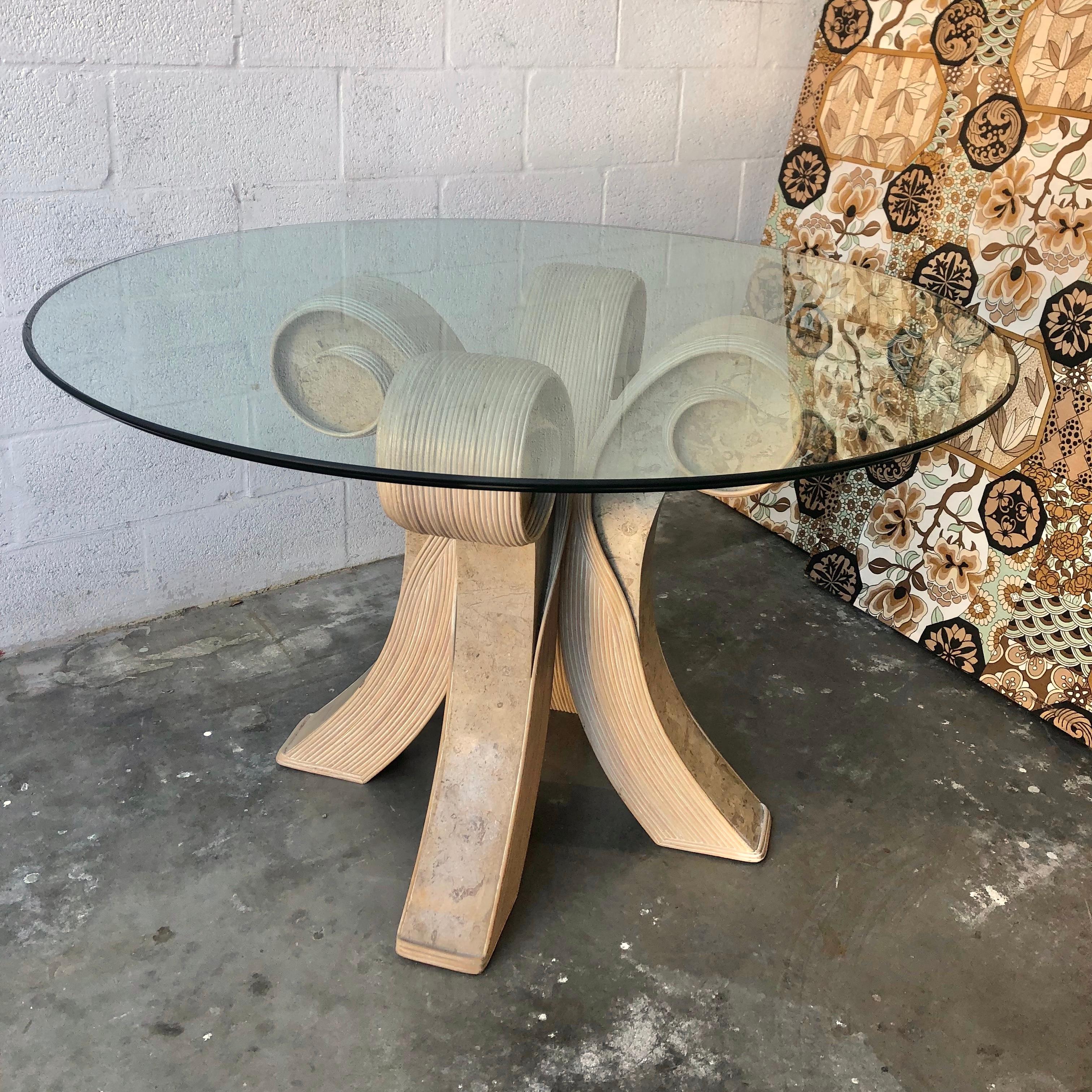 Late 20th century coastal twisted pretzel rattan glass top dining / entry table in the manner of Betty Cobonpue. Dated 1998
Features a beveled glass top and a sculptural pedestal that combines faux stone with cerused finish twisted pretzel rattan.