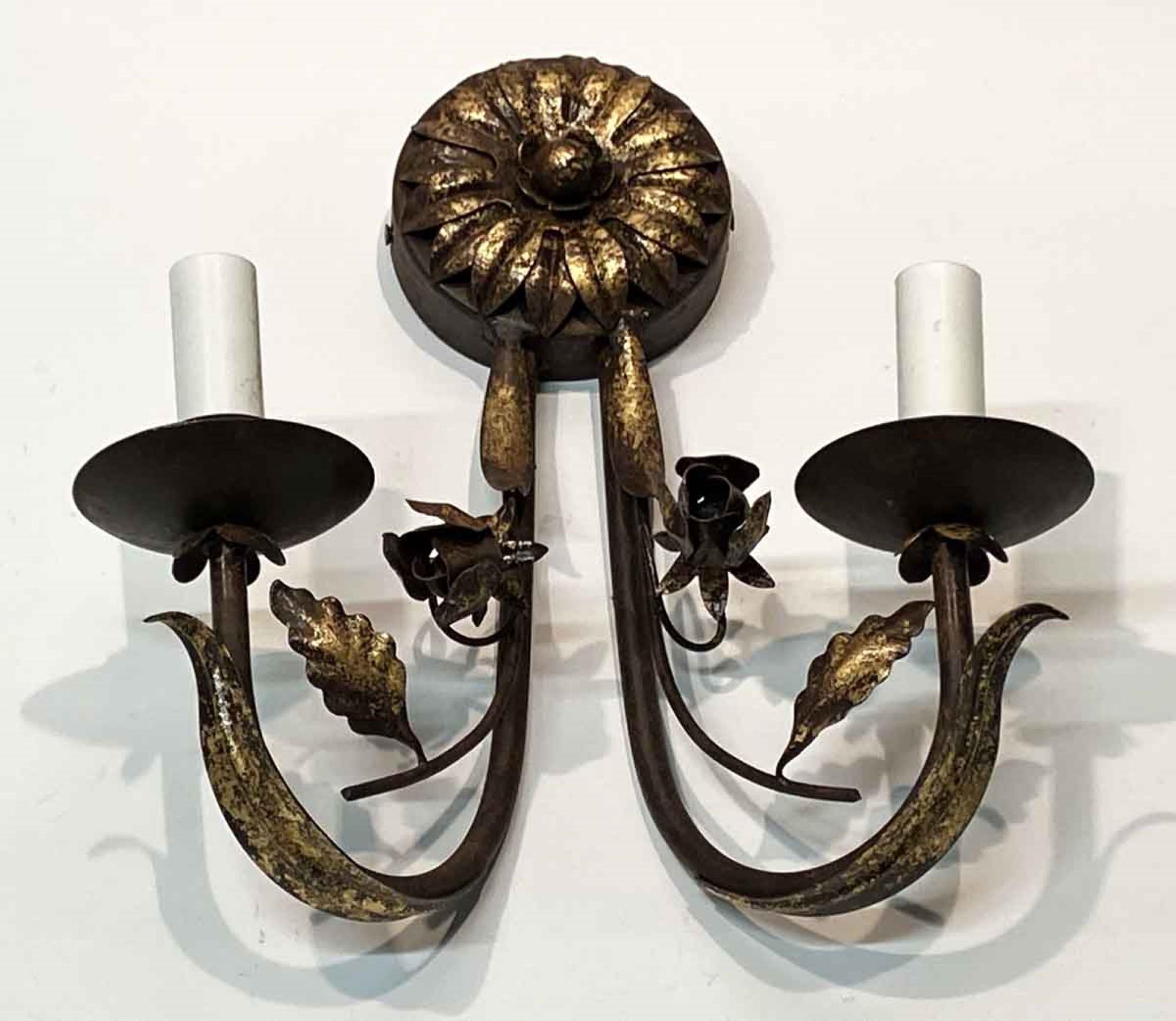 2000s hand wrought Florentine style iron sunflower sconce in a gold gilt finish. Uses two candelabra bulbs. Small quantity available at time of posting. Priced each. Please inquire. Please note, this item is located in our Scranton, PA location.