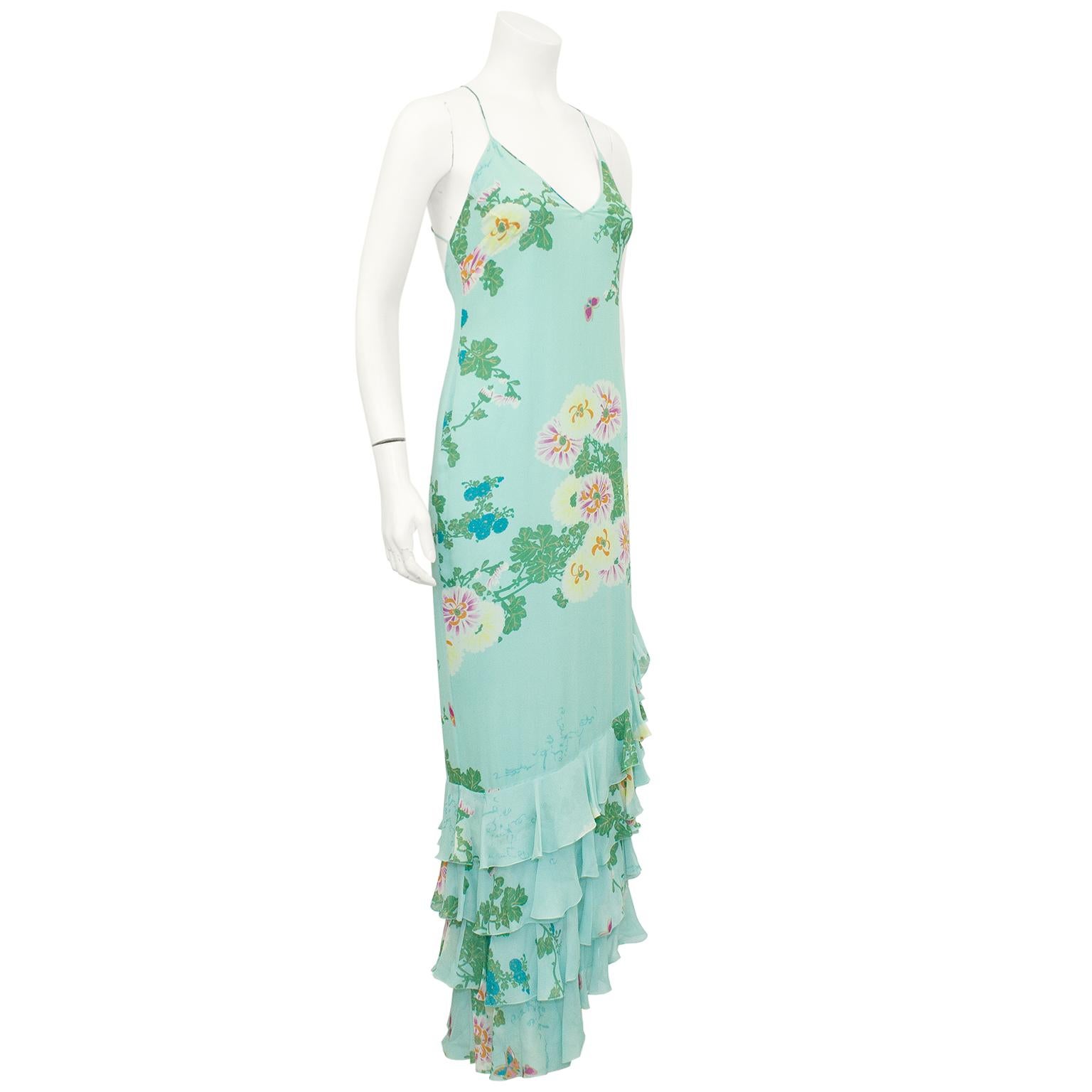 Etherial Emmanuelle Ungaro silk chiffon gown from the 1990s. Sea foam blue with an all over large floral and leaf print. V neckline with very thin straps that cross at the upper back The bias cut gown skims the body and features an asymmetrical hem