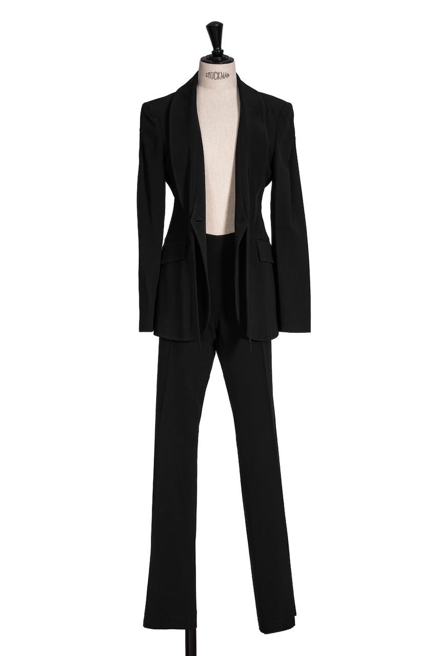 This is a stunning beautifully tailored black Valentino suit from the 1990s. It has a sleek, minimalist and yet feminine feel.

Both pieces are made in Italy from a fine black rayon blend fabric that is light in weight and has a slight texture. It