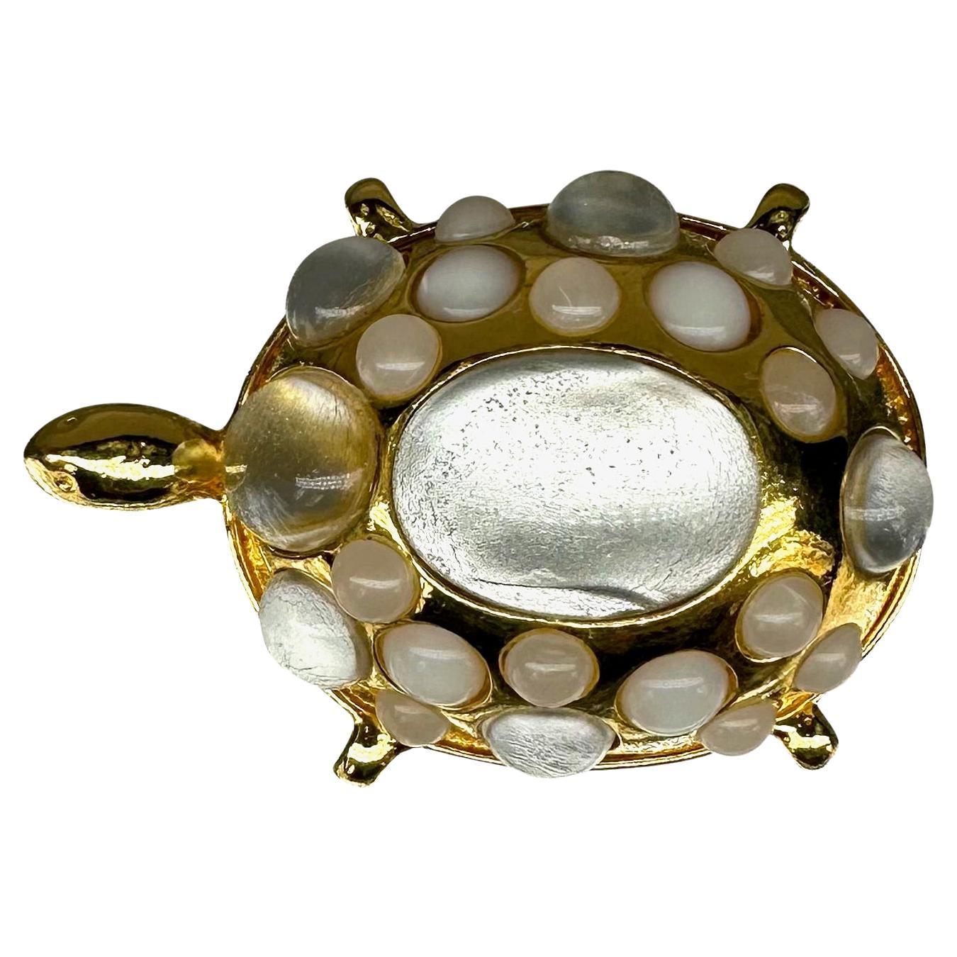 Presenting a fabulous gold-tone Valentino Garavani Couture costume turtle brooch. From the 1990s, this beautiful turtle brooch is made complete with faux opal cabochon stones on the shell. The perfect vintage couture touch to any outfit, this