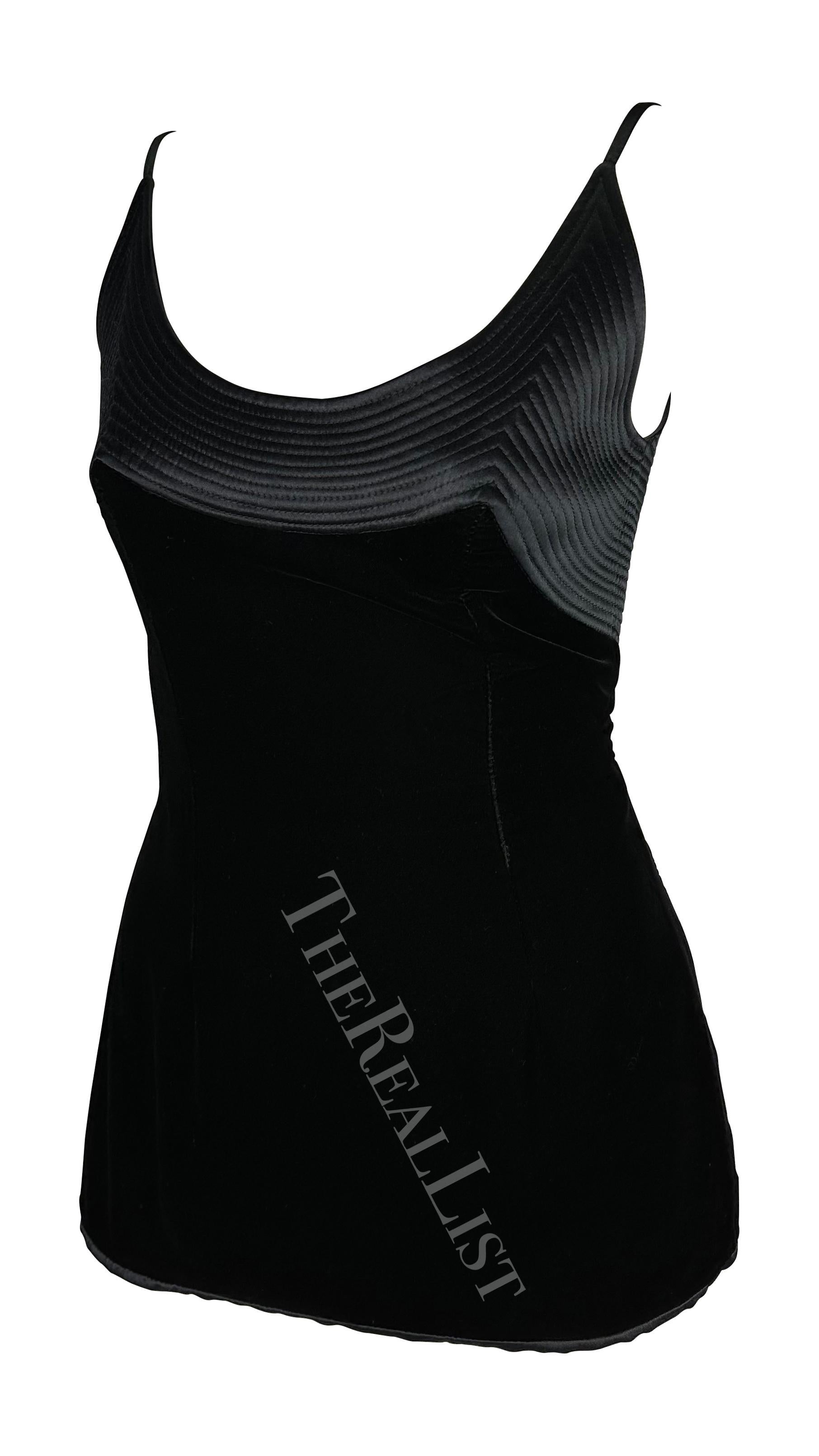 Presenting a black velvet Valentino tank top. From the 1990s, this top features a wide scoop neckline, velvet body, and quilted satin detail at the bust. The top is made complete with a zipper closure at the semi-exposed back. 

Approximate