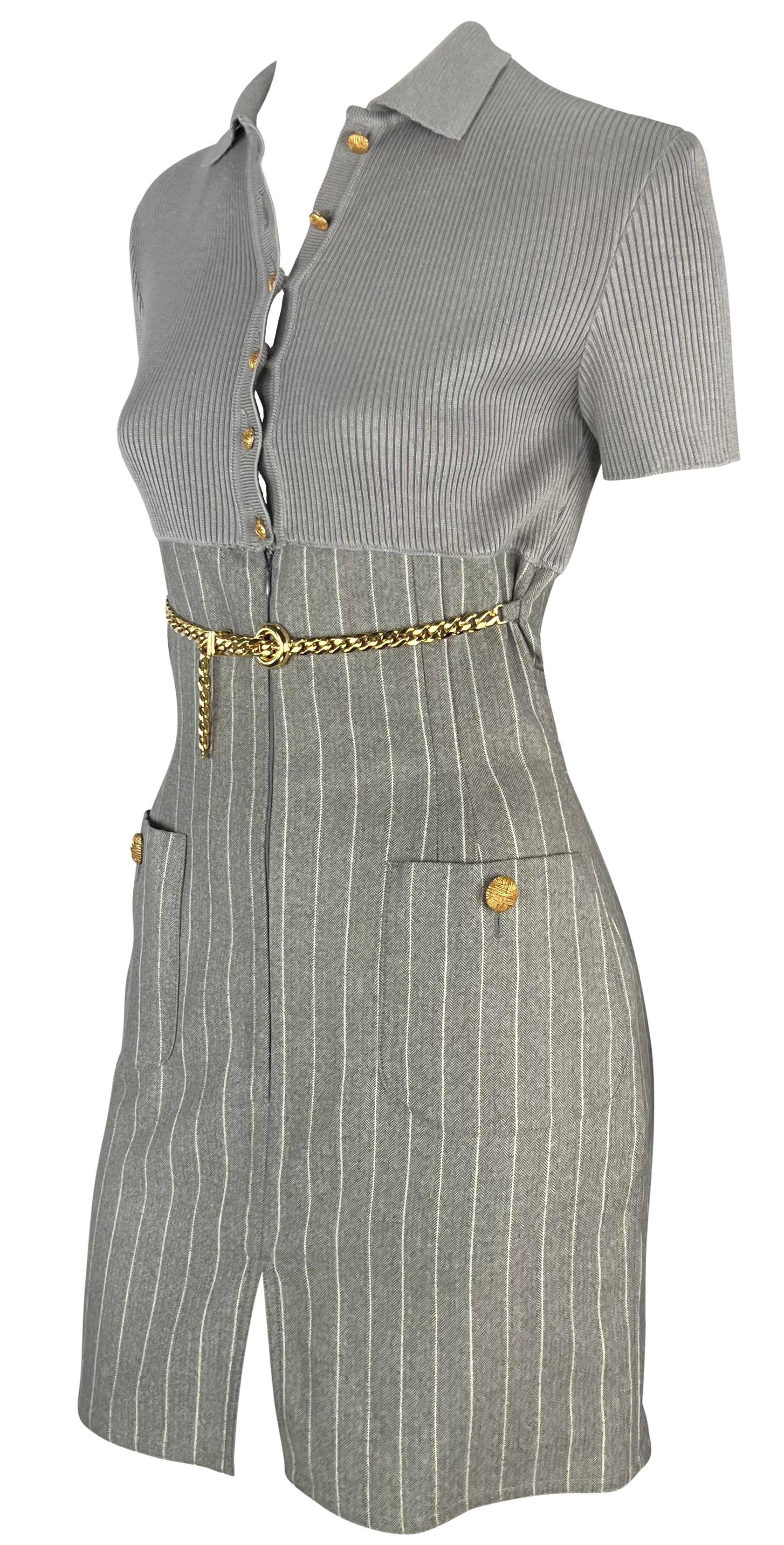 From the 1990s, this grey Valentino collared mini dress features a fold-over collar, button-down closure at the bust, and short sleeves. The top of the dress is knit and perfectly ties into the pin stripe skirt. This corporate core mini dress is