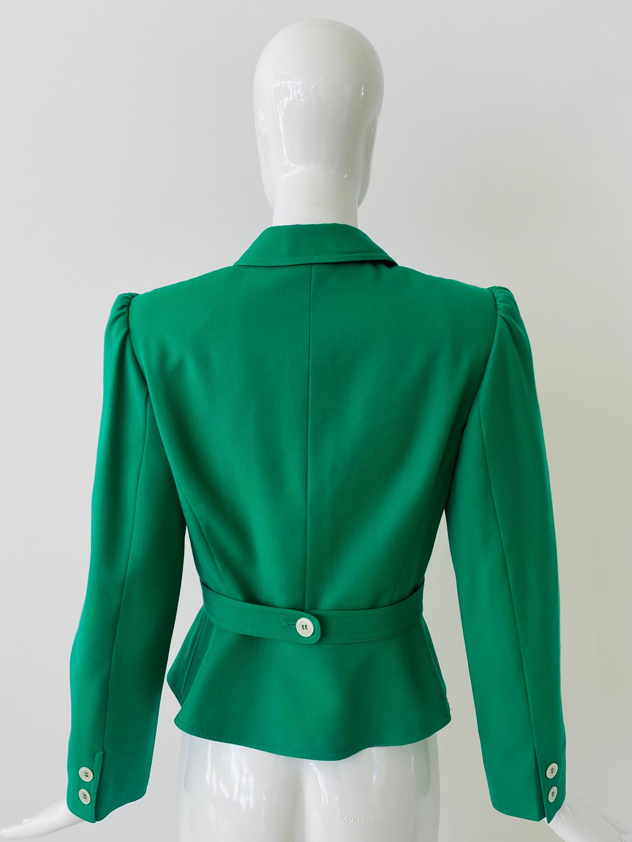1990s Valentino jacket in Kelly green with white buttons. It has beautiful structured puff shoulders and a peplum ruffle hem.  There is a single button strap at the back to pull in the waist and could be used to modify the fit of the jacket as