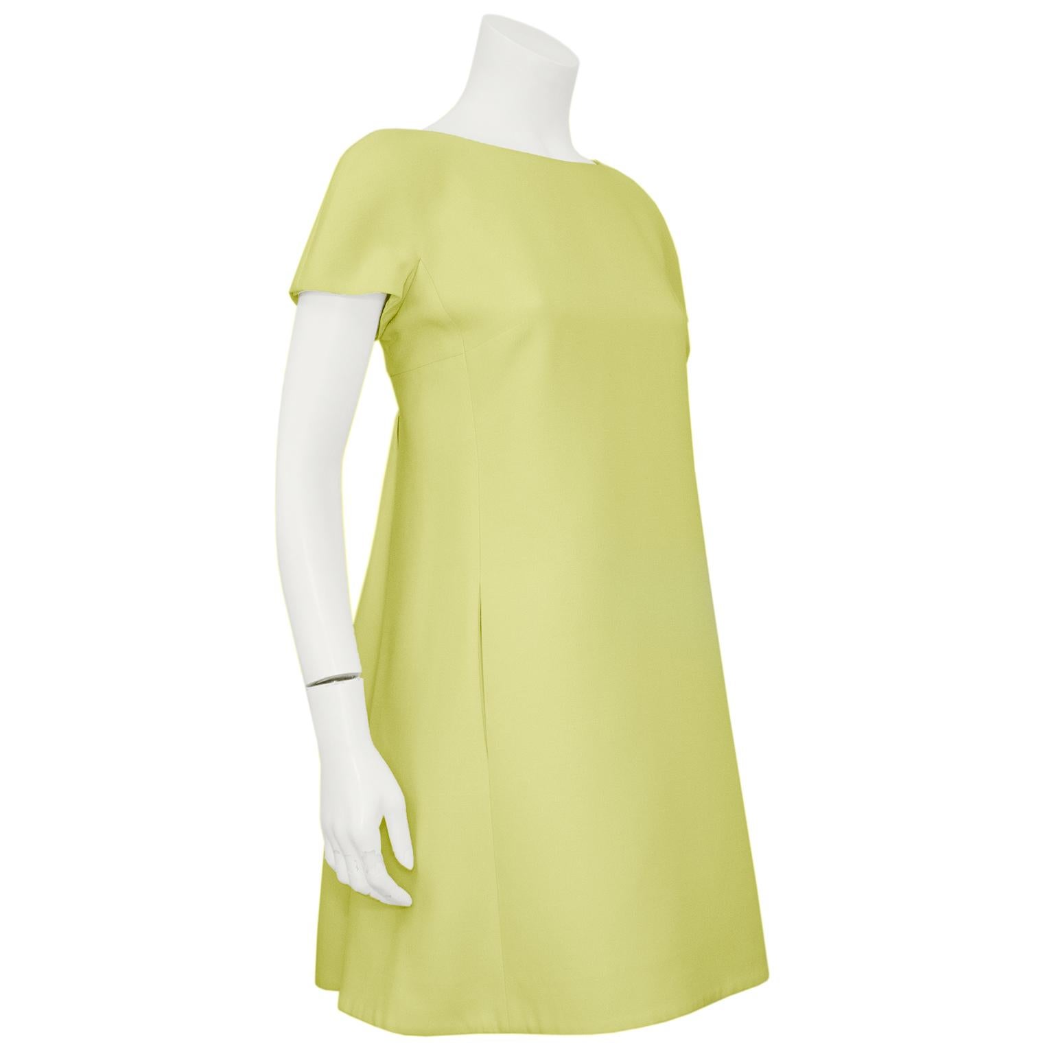 Super fun Valentino 1960's retro looking mini dress from the 1990s. Short cap sleeves with a boat neckline and an A-line shape. Darts at the bust and vertical slit pockets hidden in the front side seams. Square cut at the back with a large single