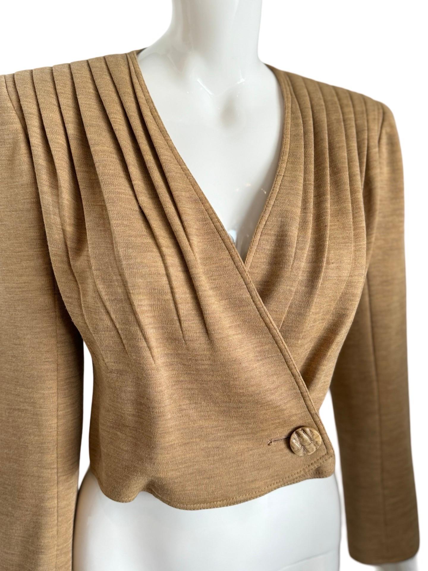 1990s Valentino Boutique cropped jacket with wide bold shoulders and cascading pleats.  The fabric is a sand color that most resembles a jersey cotton and gives off an almost athlesiure vibe.  It could also be a cotton mix. The front crosses over