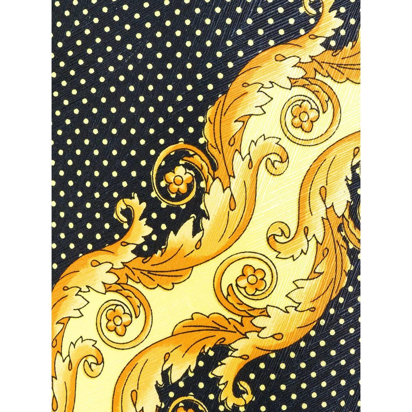 Versace black silk tie with white polka dots and contrasting yellow and gold baroque print motif. Pointed design.

Years: 90s

Made in Italy

Width: 9,5 cm
