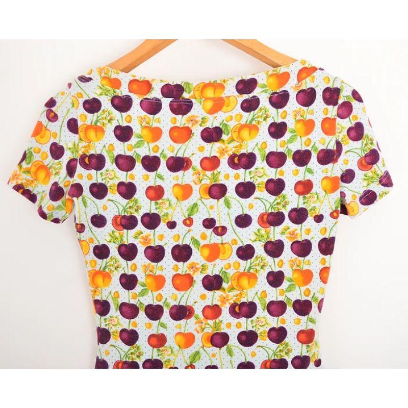 Early 1990's Versace Jeans Couture T shirt by Gianni Versace, depicting colourful, orange & purple cherries on a pastel blue Polka dot base.

The fabric is soft and stretchy, it that contours the natural body shape for a super flattering fit.

(We