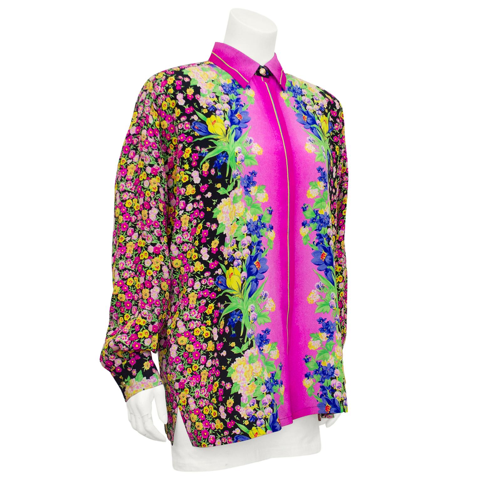 Bright and interesting GV Versatile Couture silk blouse. Allover mixed florals. Back, sides and arms are a pink and yellow floral chintz on black background. Center features green, blue and yellow mixed flowers on a bright magenta ombre background.