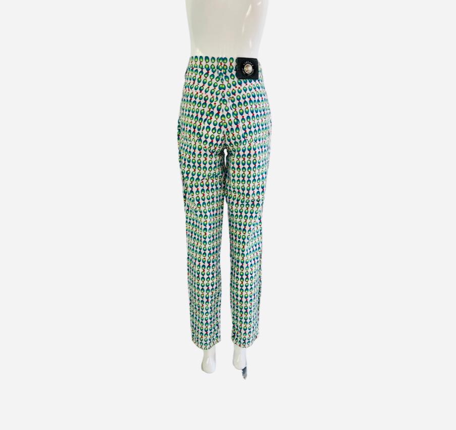 1990s Versace Jeans Couture soft cotton jeans with a olive type print on a white background.  Ovals in an ombre blue to yellow color and red dots.  Silver medusa Versace buttons on the corners of all 5 pockets. These are made of a lighter soft