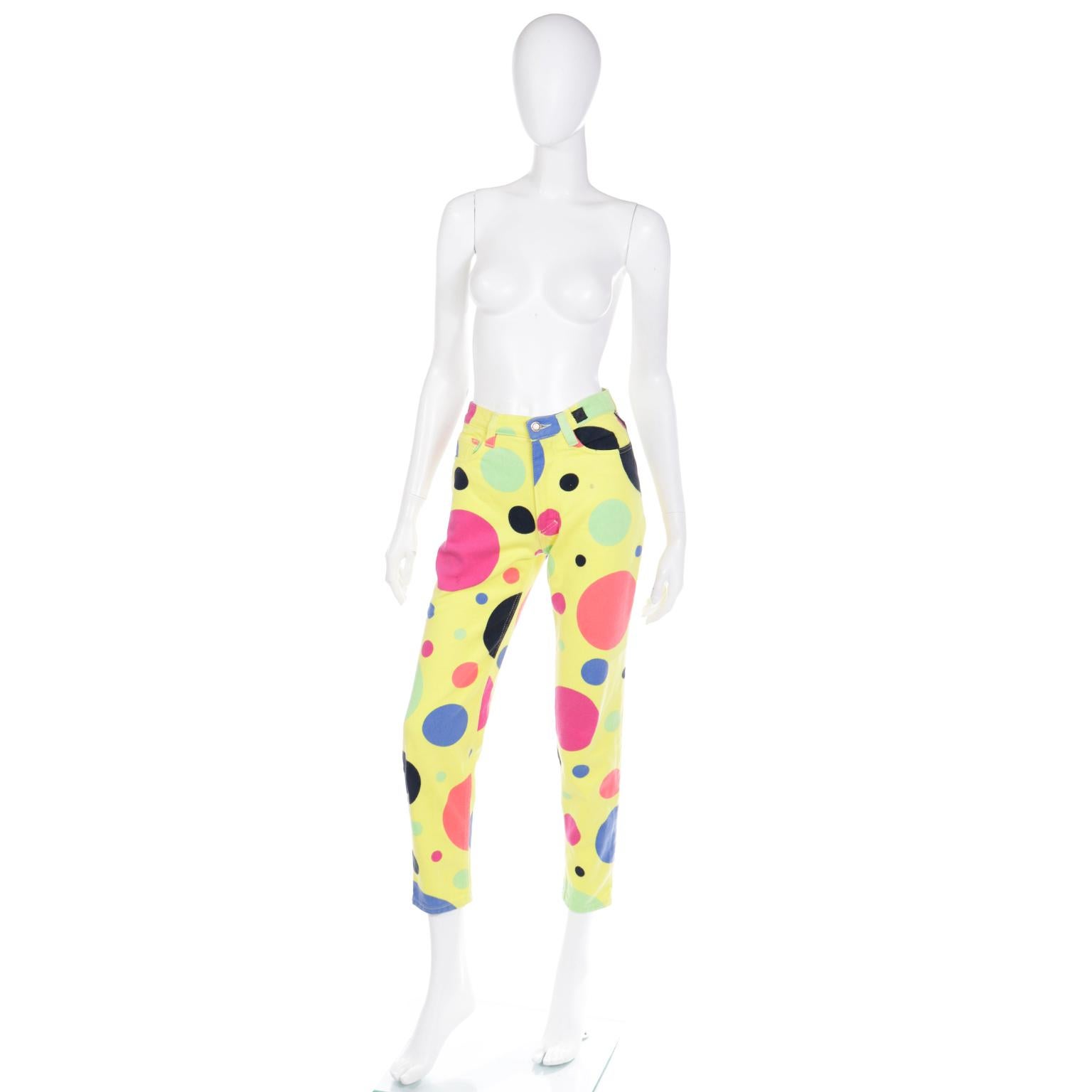 These are super fun, rare vintage 1990's Versace Jeans Couture pants! These great jeans have a bold yellow background that is covered with various sizes of bright multi colored polka dots in shades of blue, green, magenta, coral and black. These