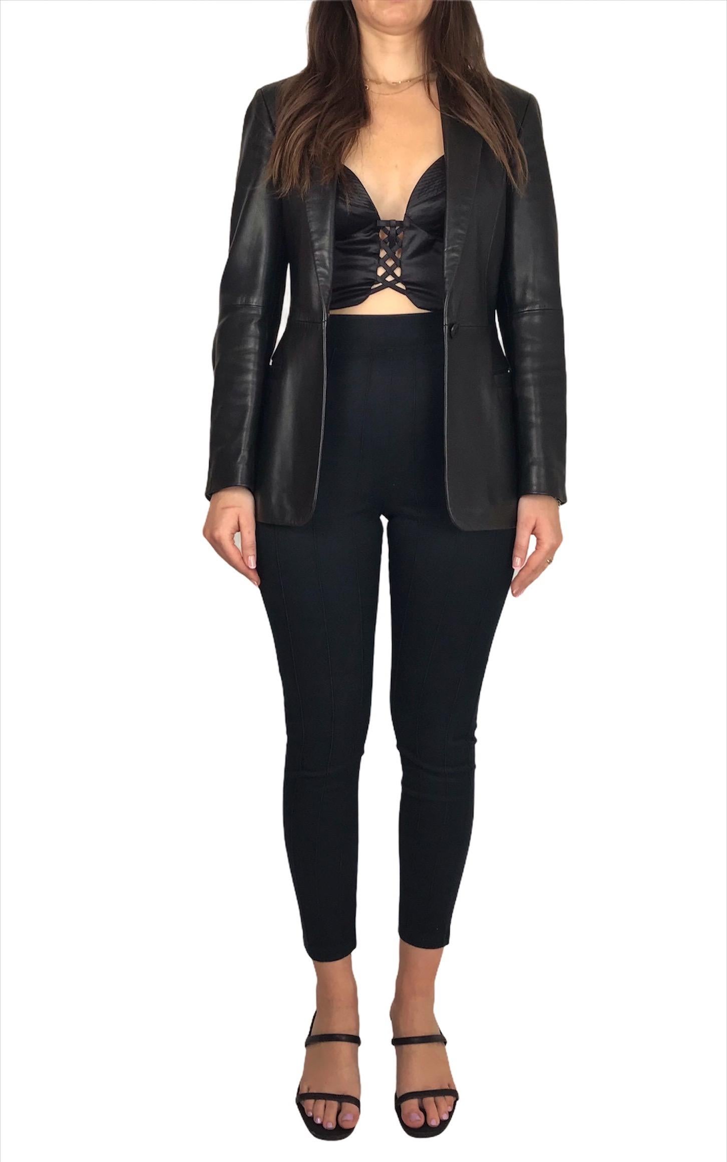 VERSUS GIANNI VERSACE, Made in Italy, circa 90’s.
Fitted black leather jacket with a button closure. Two pockets. 
Long sleeves with two buttons on each wrist. 
Viscose lining signed 