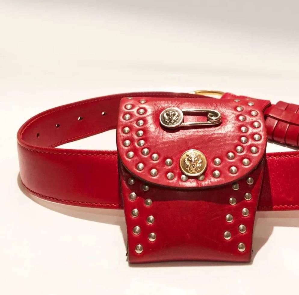 Versus By Versace  belt red purse, lion and Medusa detail, studs, flap buttoned closure, to wear as a belt purse 
Condition: very good, some slight signs of wear at the back but overall good, 1990s 
Dimensions: 13x6 cm 