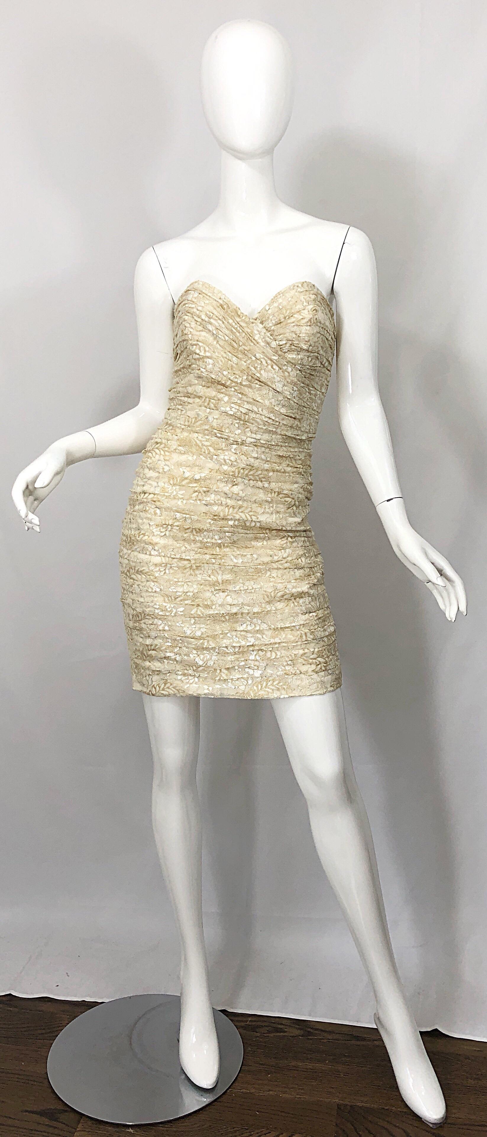 Sexy 1990s VICKY TIEL gold and ivory lace Size 8 bodycon mini dress! Features flower printed panels of lace throughout. Features signature flattering ruching throughout. Interior boning on the bodice keeps everything in place. Fully lined. Hidden