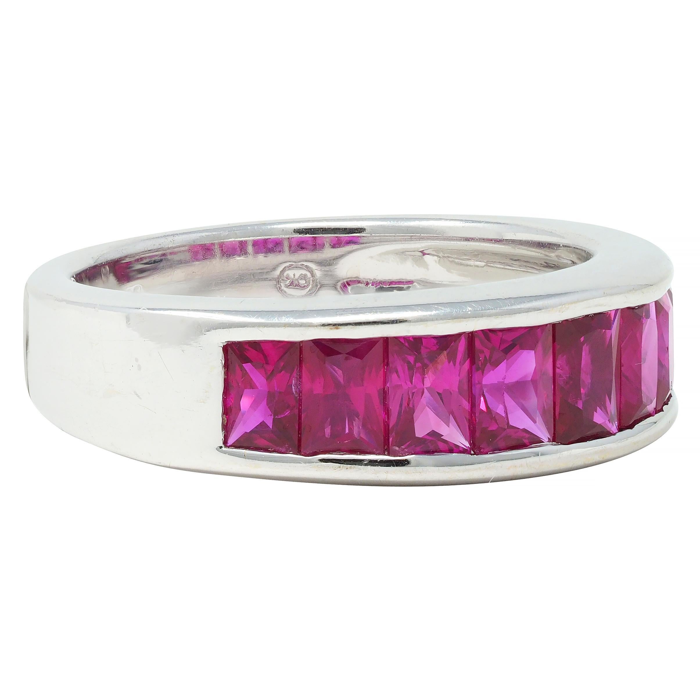 Band ring is channel set to front by eight scissor-cut rubies - graduating in size
Weighing in total approximately 2.00 carats
Eye clean with very well-matched purplish-red color
Maker's marks and stamped 750 for 18 karat gold
Circa: 1990s
Ring