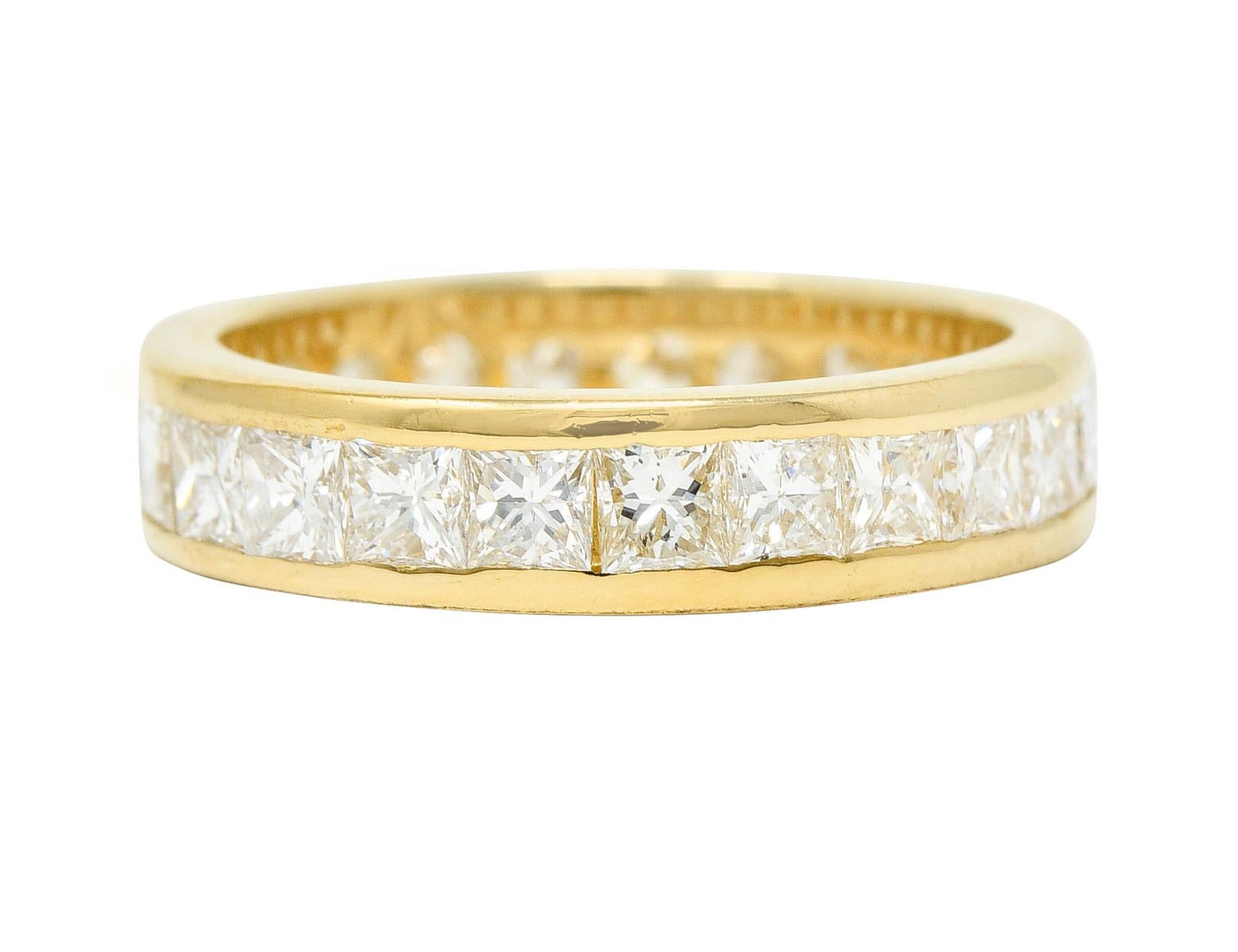 Band ring is channel set fully around with princess cut diamonds

Weighing in total 2.50 carats with G to I color and primarily SI in clarity (some VS)

Completed by polished gold channel walls

Stamped 14 karat gold

Circa: 1990s

Ring Size: 5 3/4