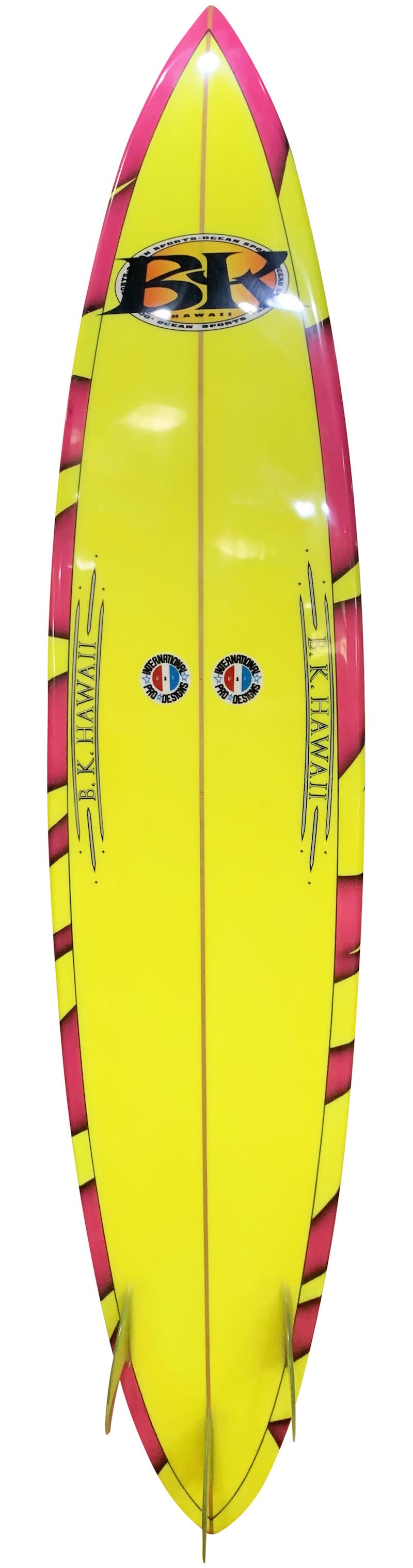 Early 1990s vintage BK Hawaii big wave gun surfboard shaped by Barry Kanaiaupuni in the early 1990s. Featuring a vibrant pink tiger stripe airbrush design and thruster fin setup. Restored to original condition.

Barry Kanaiaupuni is best known for