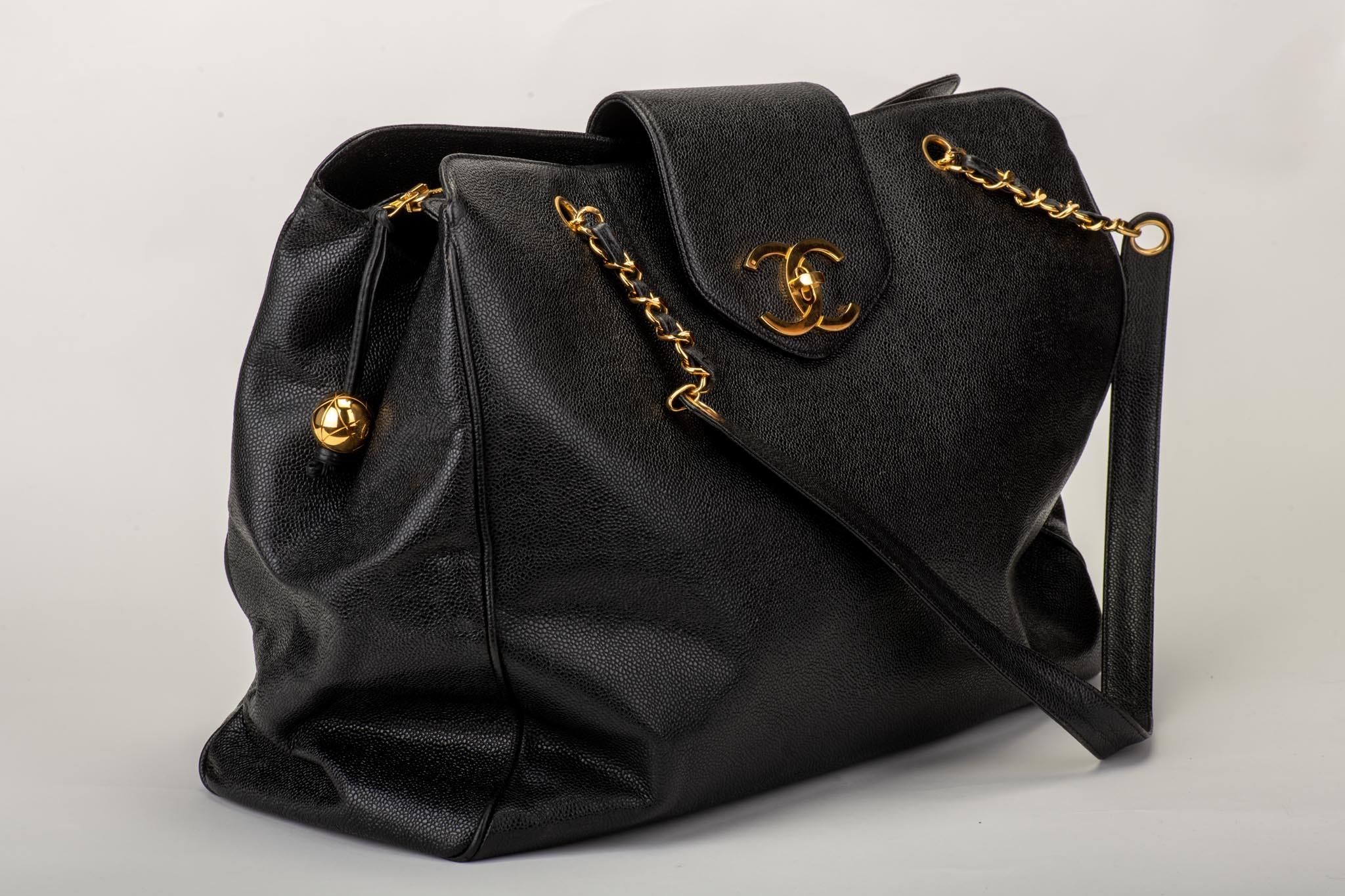 1990s Chanel weekender bag in black caviar with gold tone hardware. Shoulder drop, 15