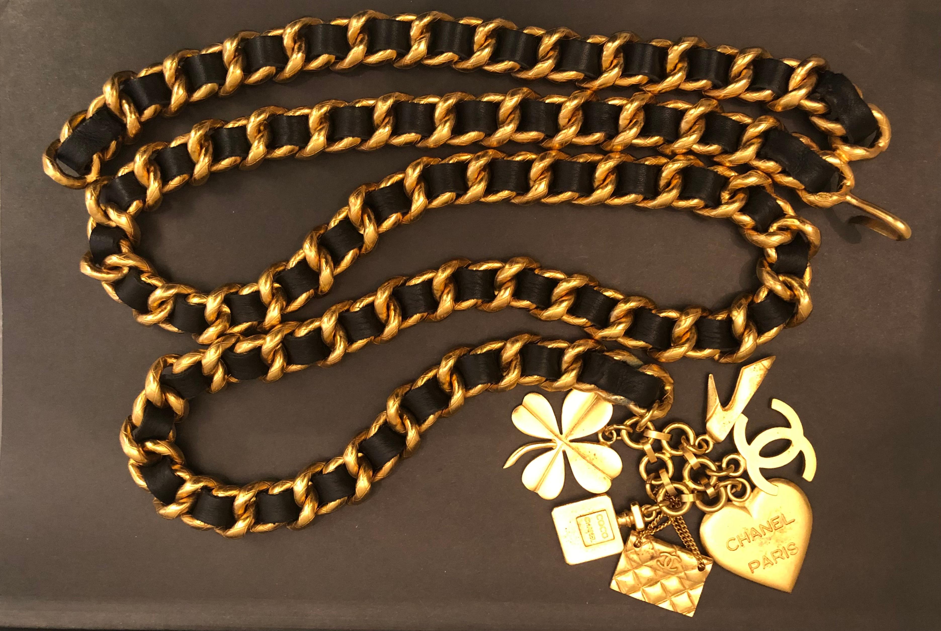This vintage Chanel gold toned chain belt is crafted of sturdy gold toned chain in quilted pattern interlaced with black leather featuring six iconic Chanel charms. Stamped Chanel 95A made in France. Adjustable hook fastening. Chain measures