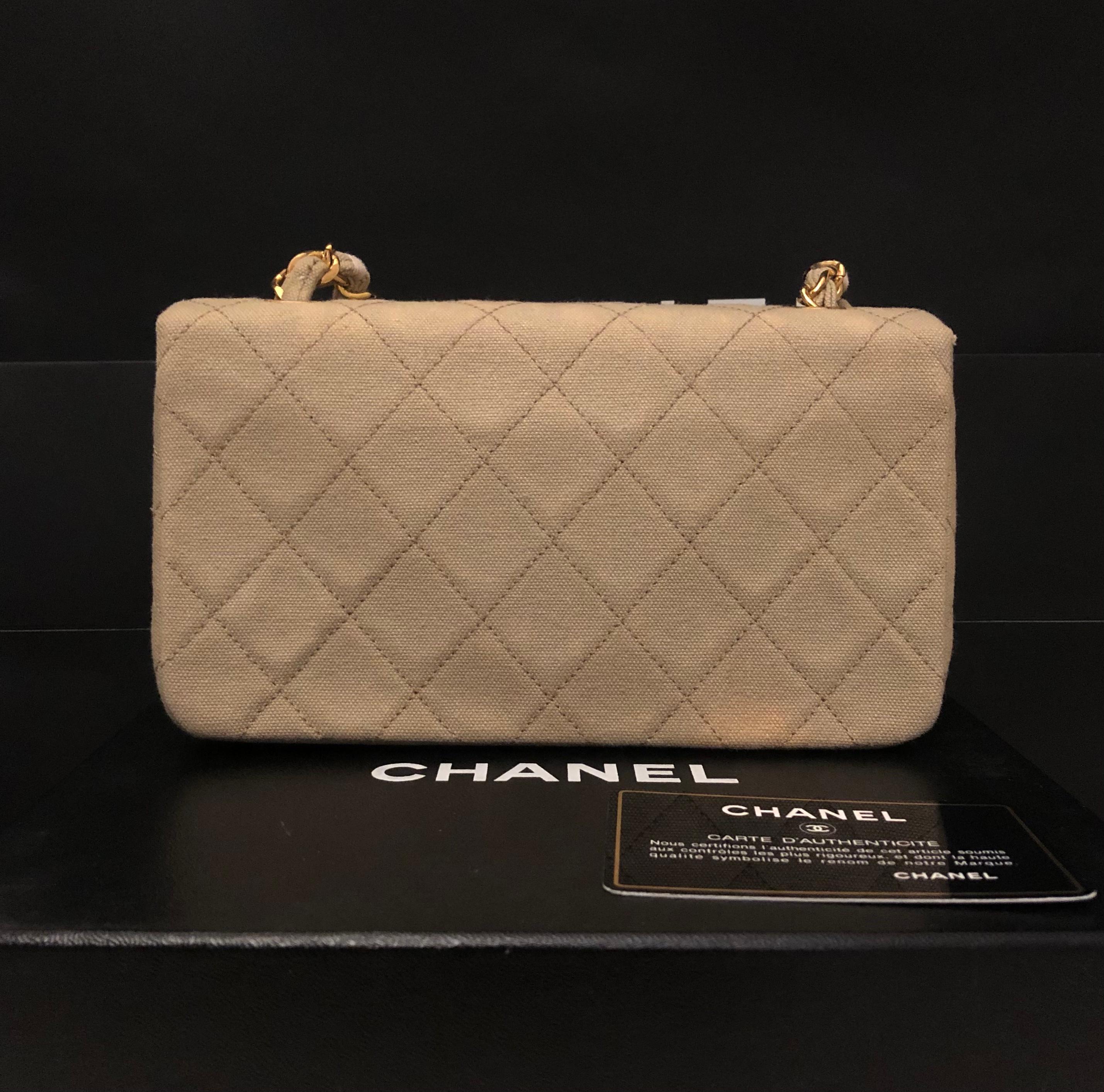 This 1990s vintage CHANEL flap bag is crafted of diamond quilted canvas in khaki and gold toned hardware featuring a gold toned chain interlaced with the same canvas. Front flap snap closure opens to a lambskin leather interior in khaki with open