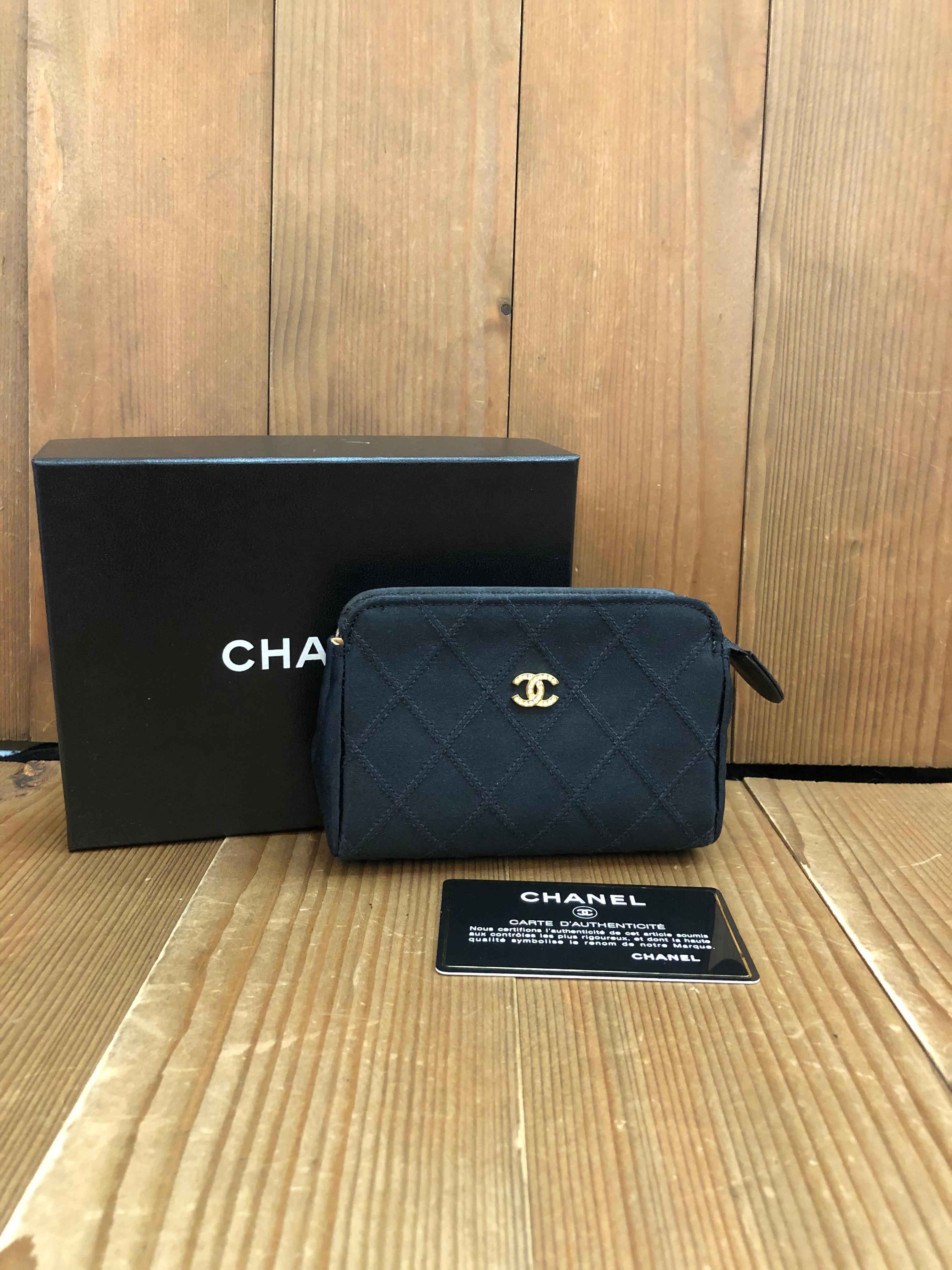 This vintage CHANEL mini pouch bag is crafted of black satin in diamond quilted pattern decorated with a gold toned rhinestone CC at the front. Top zipper closure opens to a new interior in beige. Measures approximately 4.75 x 3.25 x 1.5 inches.
