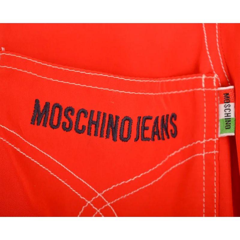 Original Vintage 1990's Moschino all in one, loose fitted, button down playsuit in the perfect shade of Bold Cherry Red featuring belt loops at the waist should you wish for a more cinched look. 

MADE IN ITALY !

Features:
'MOSCHINO JEANS' breast