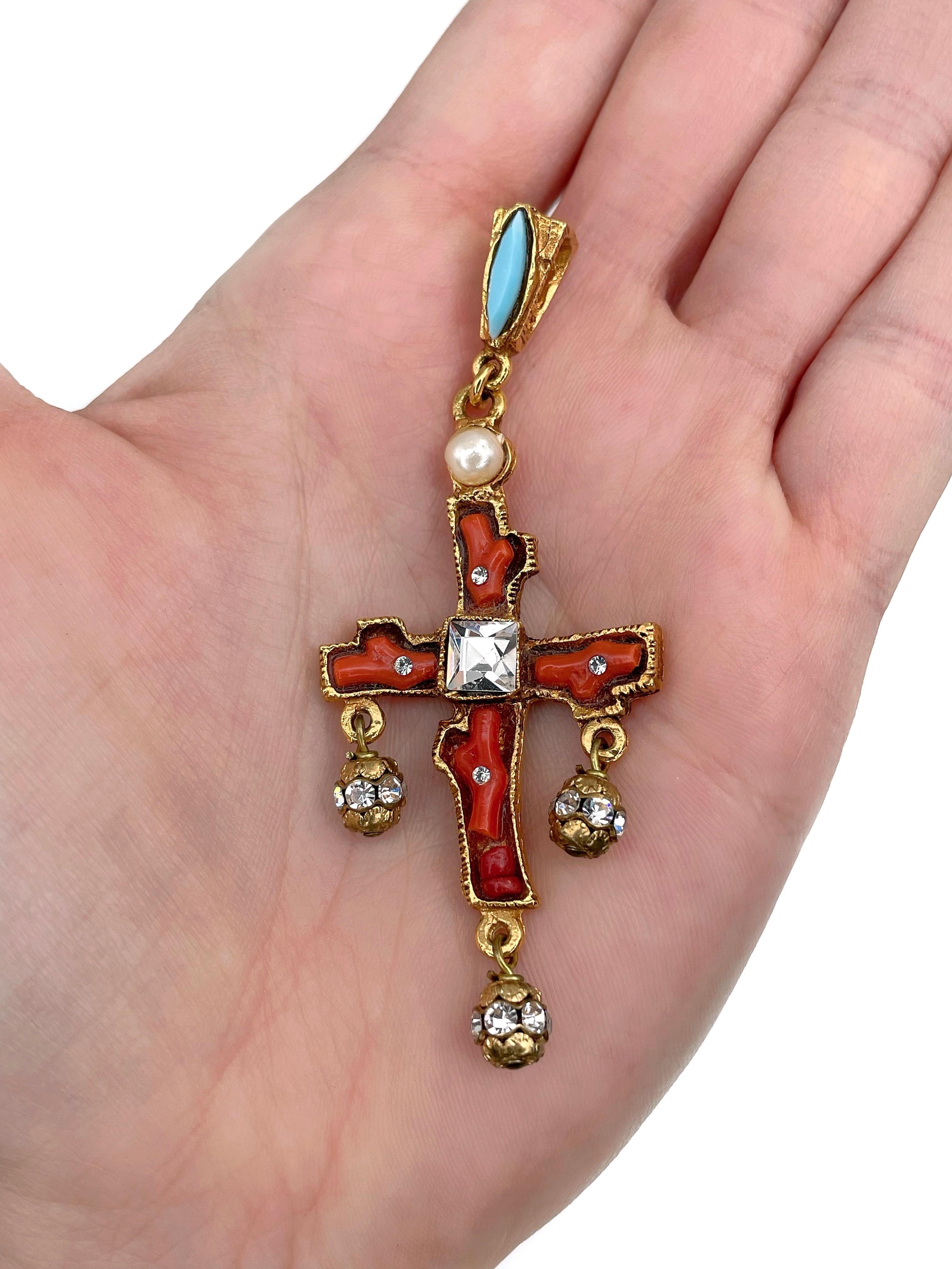 This is an amazing gold tone cross pendant designed by Christian Lacroix in 1990’s. The piece is crafted in base metal and is gold plated. It features clear crystals, faux corals, faux turquoise and faux pearl.

Signed: “Christian Lacroix - CL -
