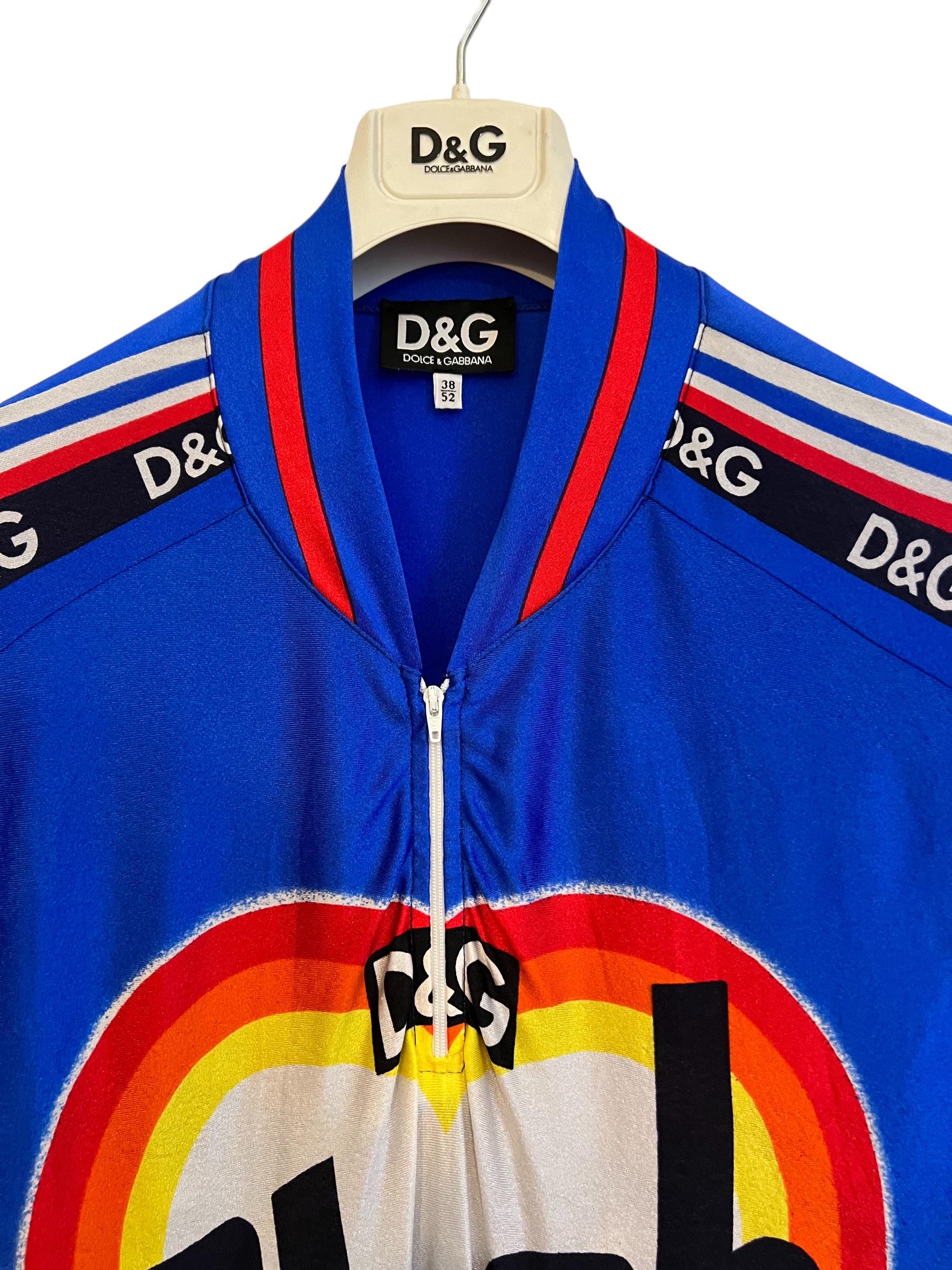 Superb, early 1990's Vintage Dolce & Gabbana Cycling Jersey style Top featuring Loud printed colouful imagery and Slogans.

MADE IN ITALY

Features:
Zip neckline
short sleeves

Sizing: 
Pit to Pit: 21