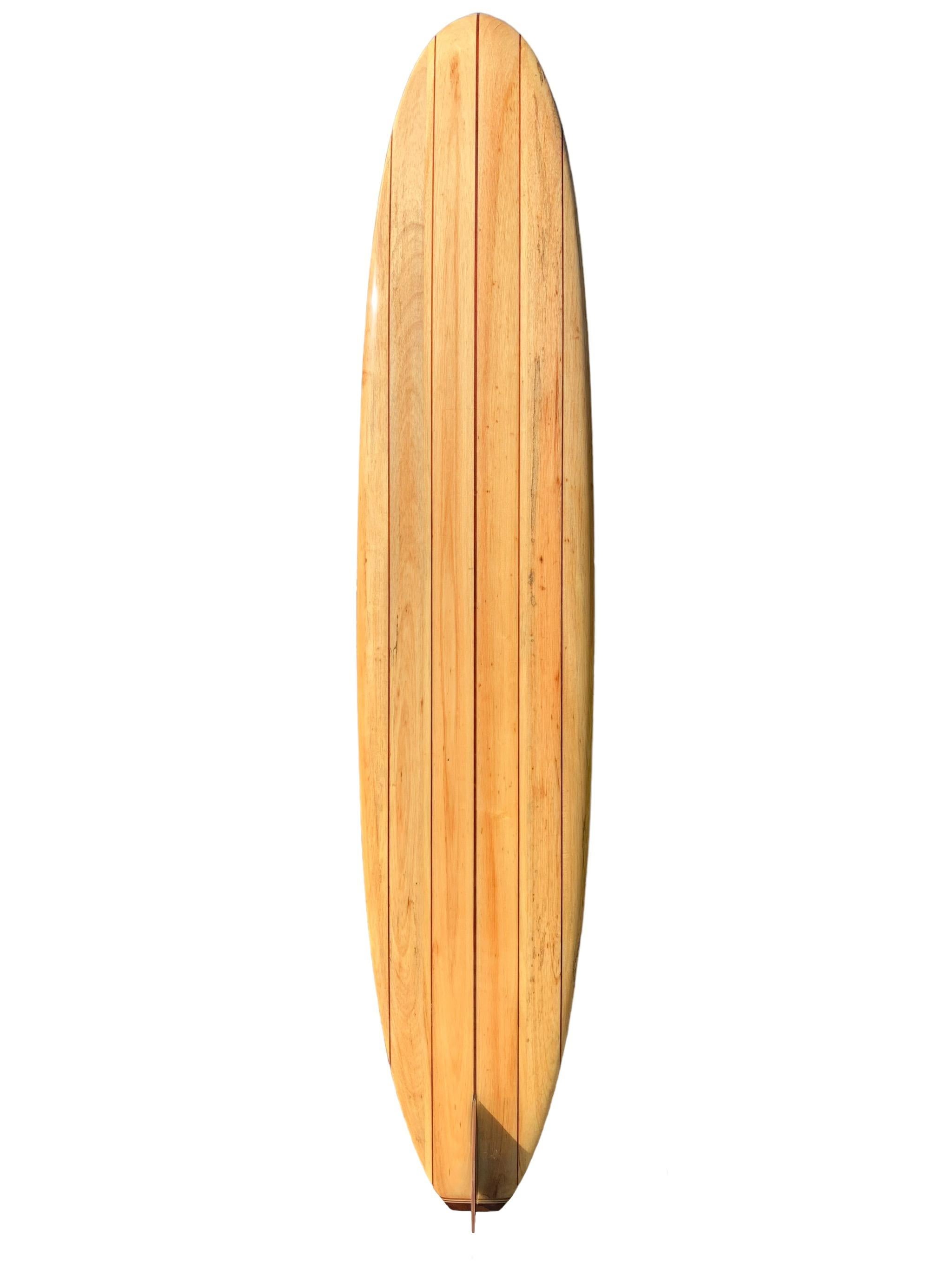 Mid-1990s Velzy balsawood longboard shaped by the late Dale Velzy (1927-2005). Features a 5-stringer design with gorgeous wood fin and tail-block. A superb example of Dale Velzy shaped balsa surfboard and beautiful functional art piece.

Velzy is