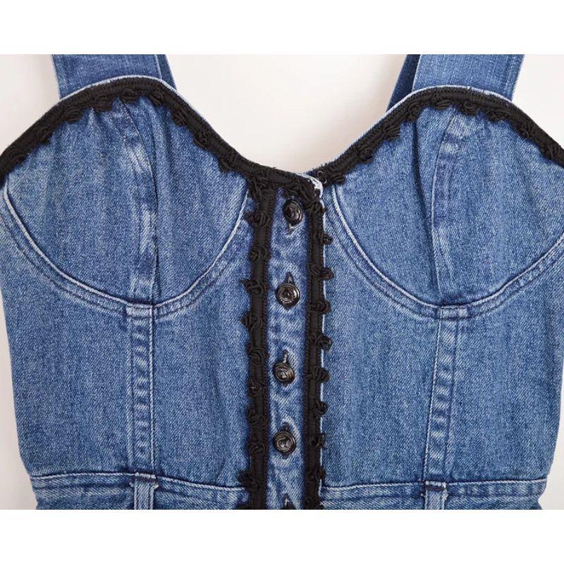 Chic and sexy early 1990's Moschino Milano blue denim fitted dress, with corset style black lace trimmed upper body contours.

MADE IN ITALY !

Features:
Buttons down the front
Skinny belt loops
x4 Pocket design
Strappy shoulders
Above the knee