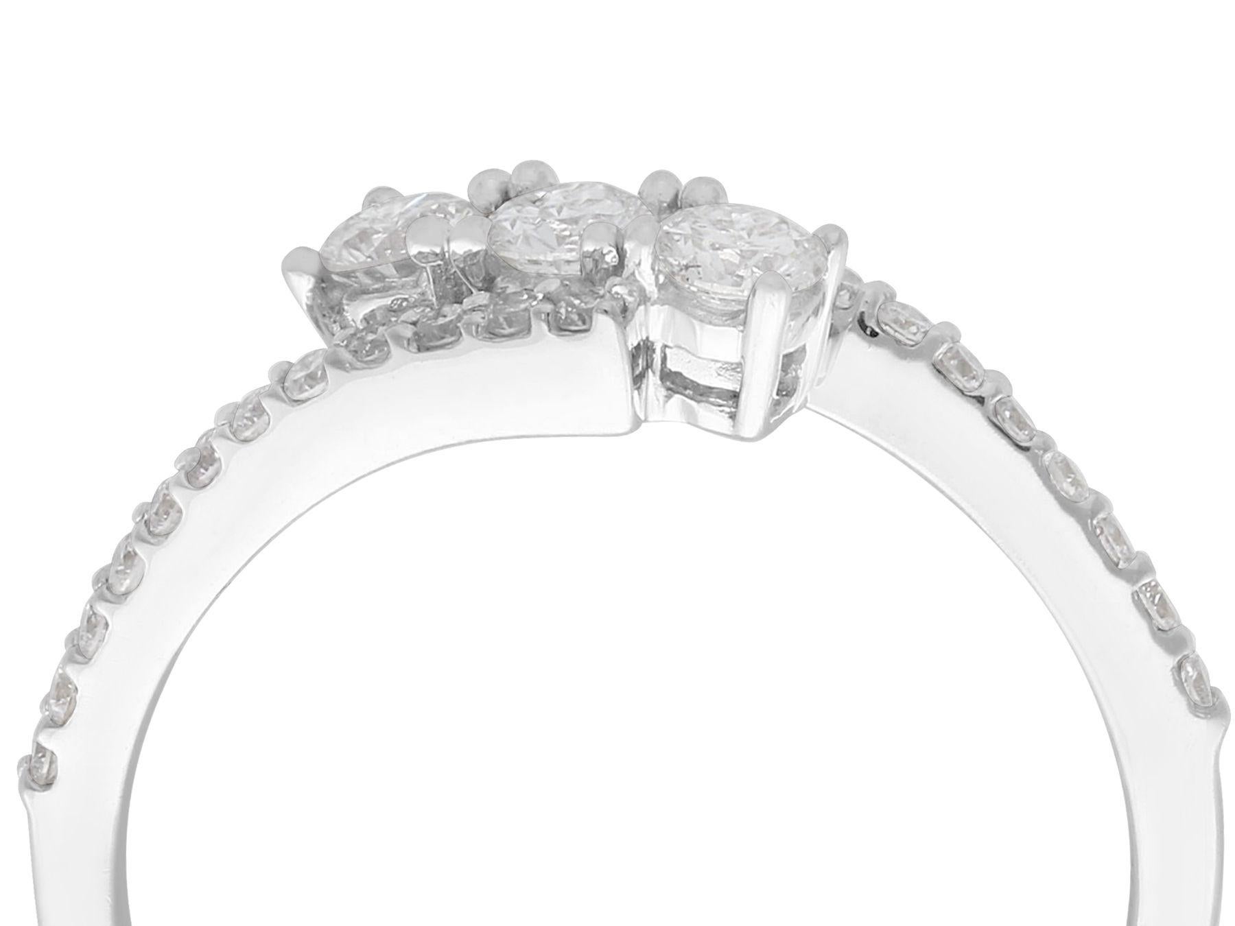 A fine and impressive 0.56 carat diamond and 18 karat white gold three stone twist ring; part of our diverse diamond jewelry and estate jewelry collections.

This fine and impressive diamond twist ring has been crafted in 18k white gold.

The twist