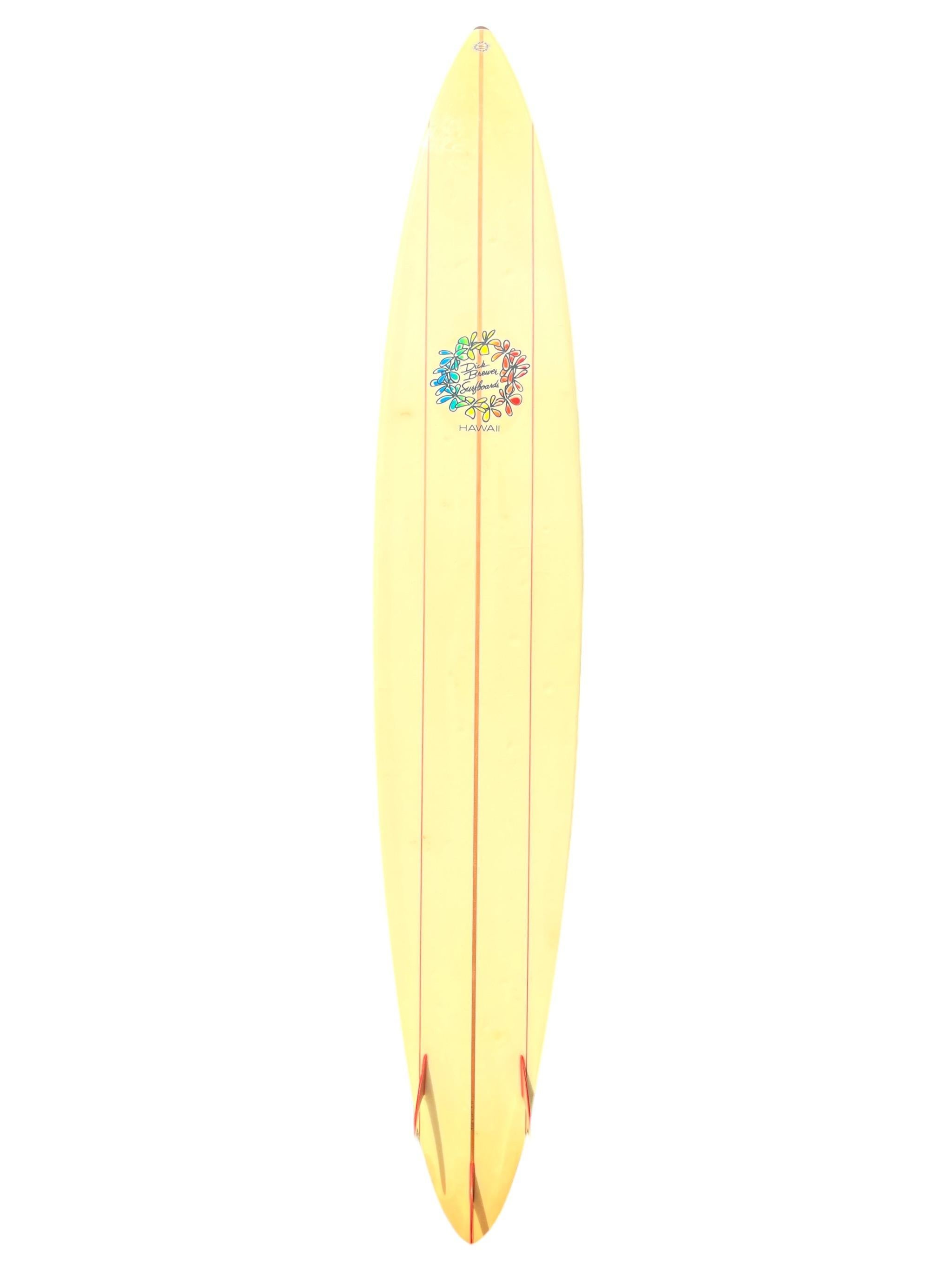 Vintage 1990s Dick Brewer Waimea Bay big wave surfboard. Hand made by the renowned surfboard design pioneer, the late Dick Brewer (1936-2022). Features a redwood triple stringer pintail shape design with beautiful red tri-fins and heavy duty double