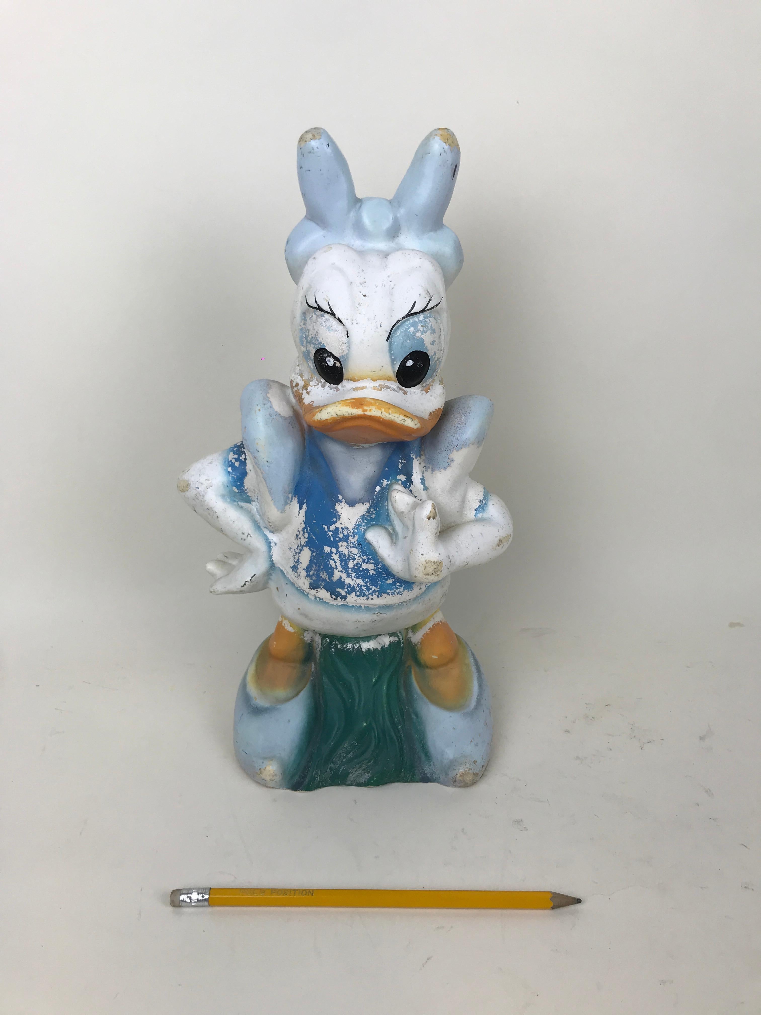 Vintage plastic garden sculpture of Daisy Duck. Made for Disney by Austrian maker Celloplast in the 1990s.

Marked Disney on the bottom right side of the sculpture and CELLOPLAST Made in Austria on bottom.
