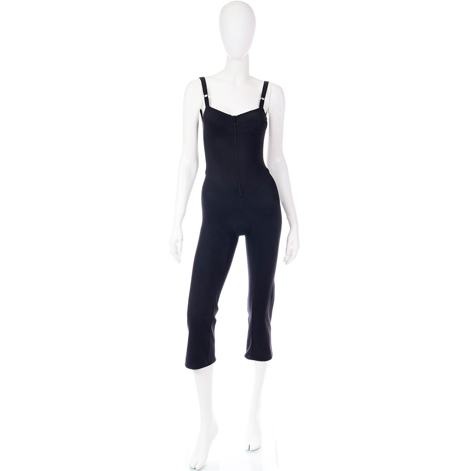 As with many of their pieces, this rare vintage Dolce & Gabbana jumpsuit was inspired by lingerie and the bodice is similar to a bustier with adjustable straps and defined bust.  This black stretch jumpsuit has a front center zipper and 