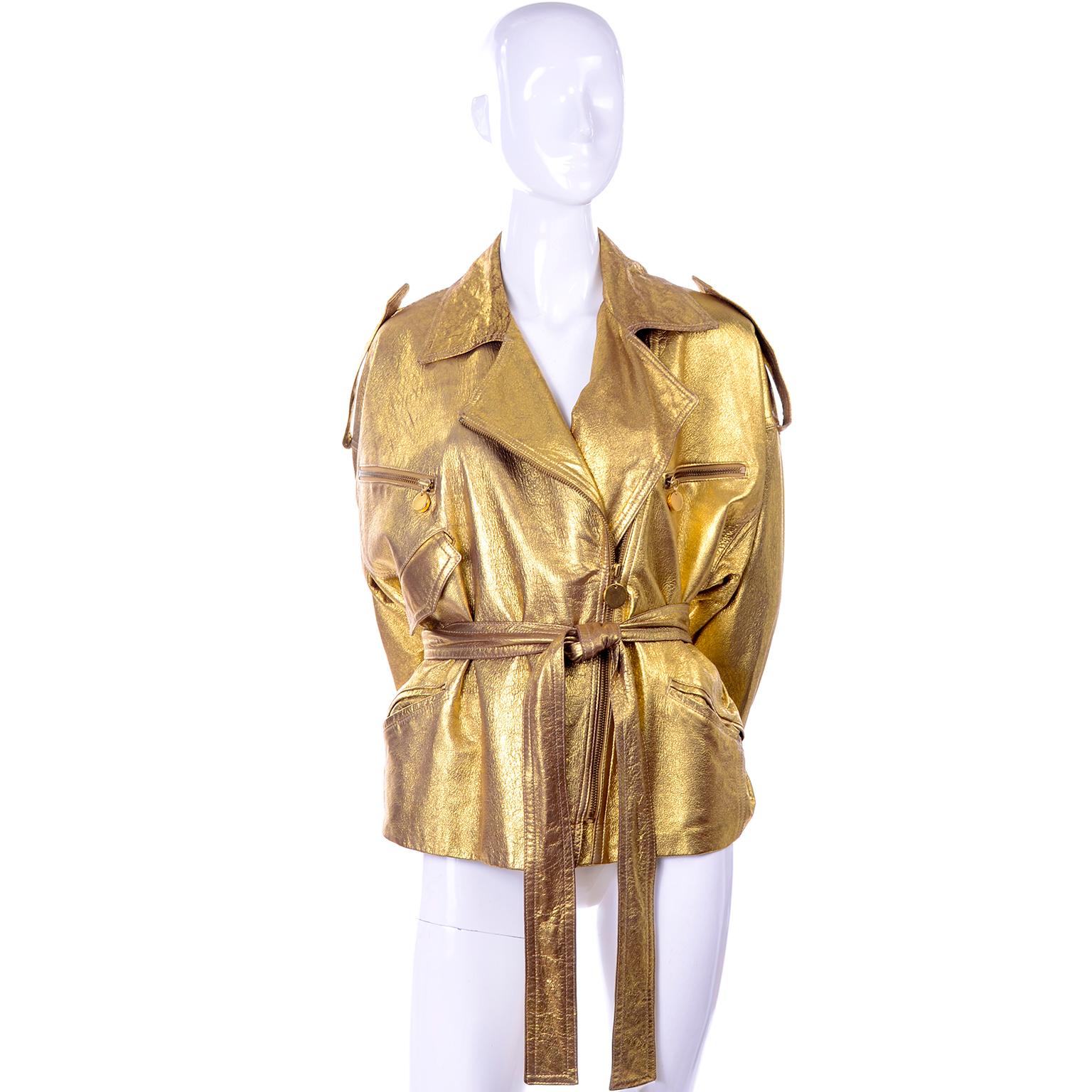 This is an incredible oversized early 1990's vintage Donna Karan gold leather jacket with a matching leather belt. We love the drama of this iconic piece and the semi distressed brilliant gold leather. The jacket is marked as size 10 but can