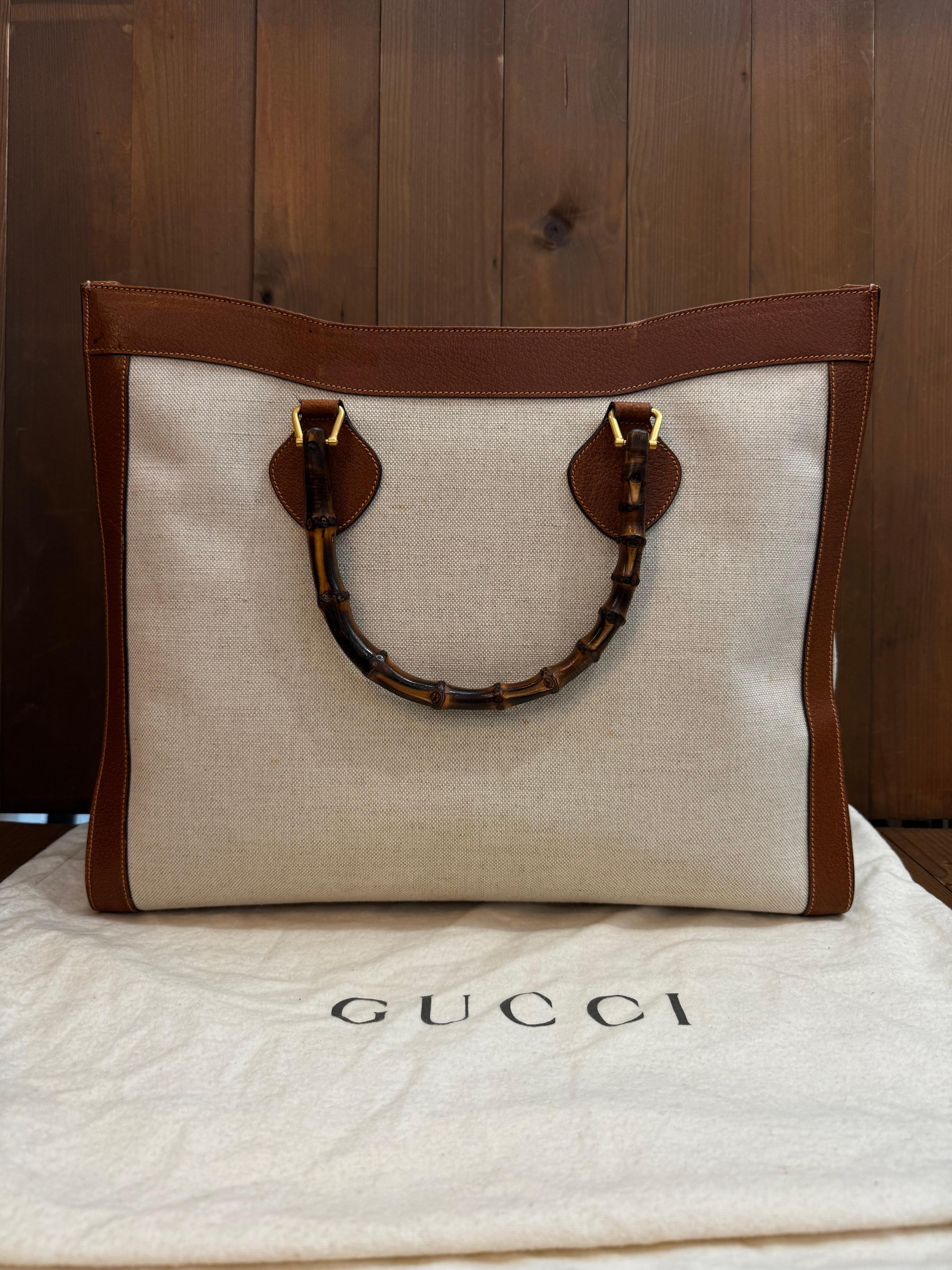 This vintage GUCCI large Diana bamboo tote is crafted of canvas in neutral color and brown pigskin leather featuring gold toned hardware and sturdy bamboo handles. The wide top opens to a spacious single compartment lined with smooth calfskin