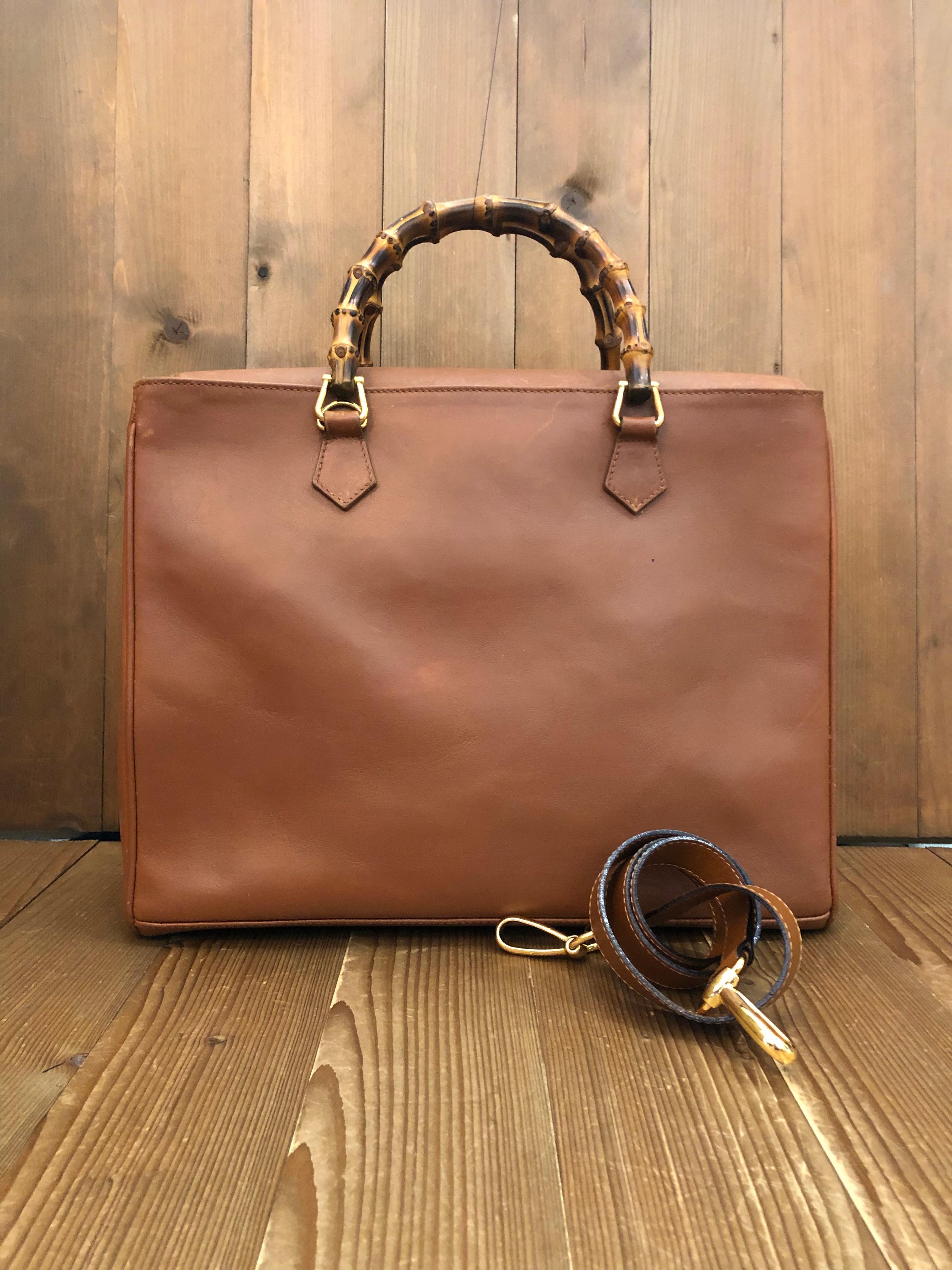 This vintage GUCCI bamboo document tote is crafted of calf leather in tan color featuring gold toned hardware. Top magnetic snap closure open to a new interior in beige featuring a zippered compartment in the middle and a zipper pocket. The front