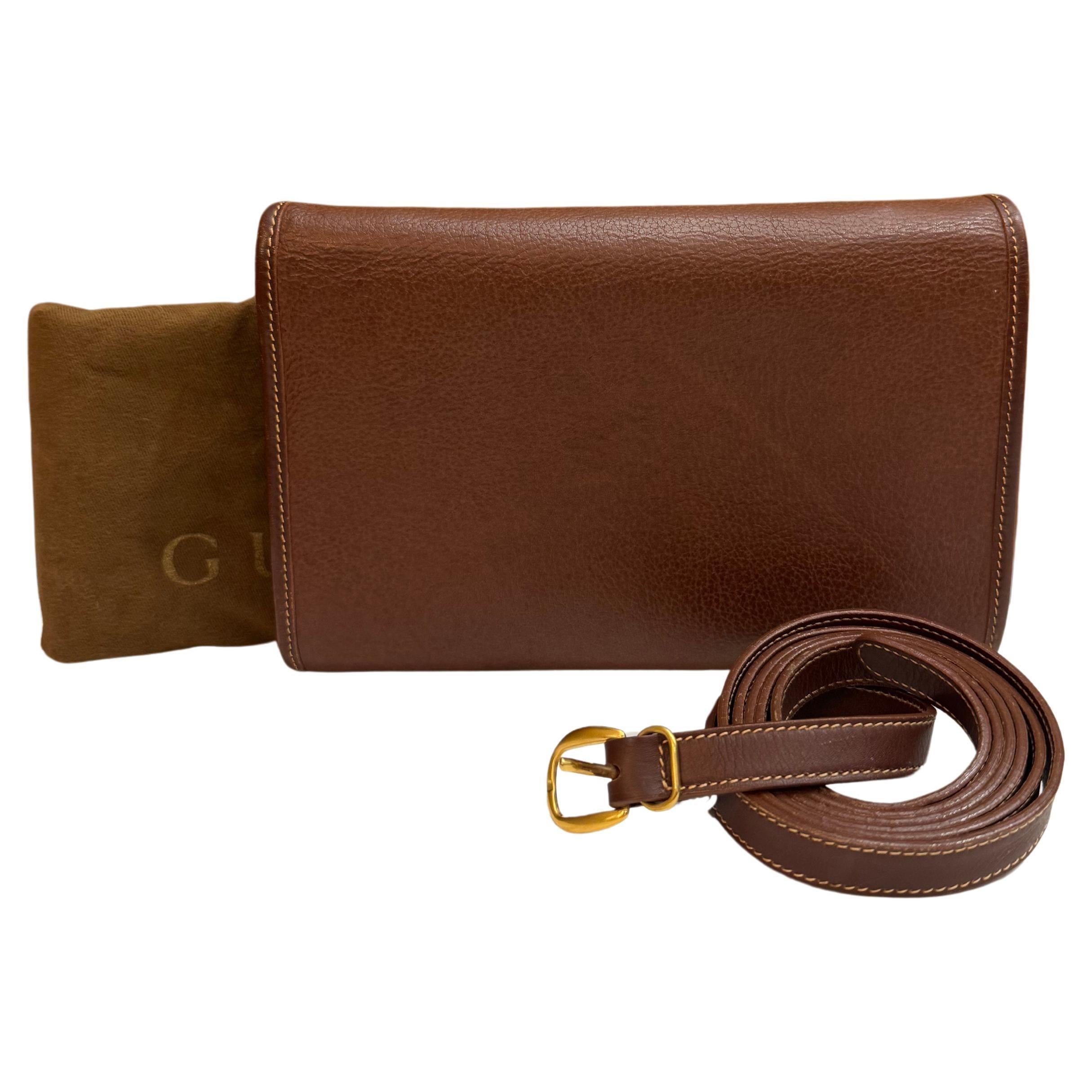 This vintage GUCCI mini 2-way crossbody bag is crafted of grained calfskin leather in dark brown featuring a detachable crossbody strap of the same leather. Front flap magnetic snap closure opens to a nubuck leather interior with a zippered pocket.