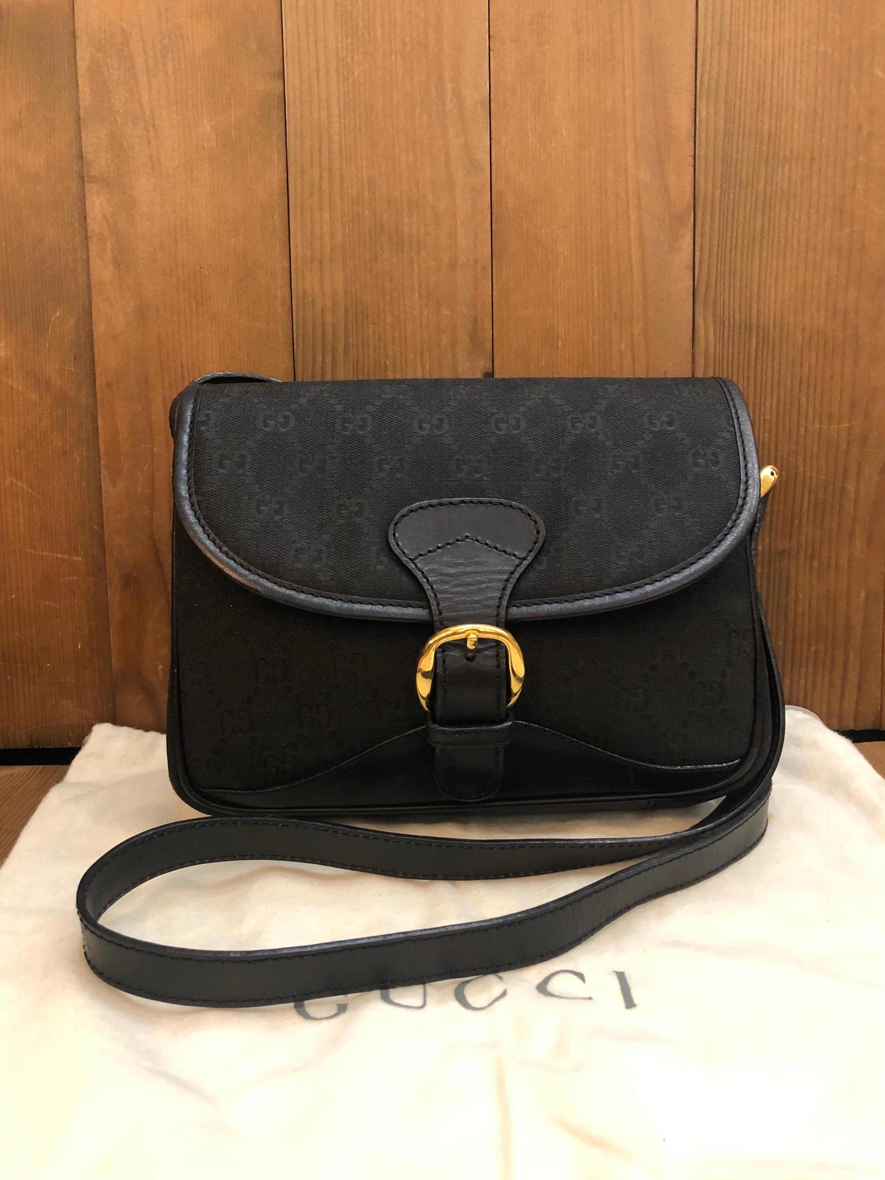 This Vintage GUCCI messenger bag is crafted of GG jacquard in black trimmed with black smooth leather. Front flap faux-buckle magnetic snap closure opens to a new interior in black featuring three main compartments and a zippered pocket. Made in