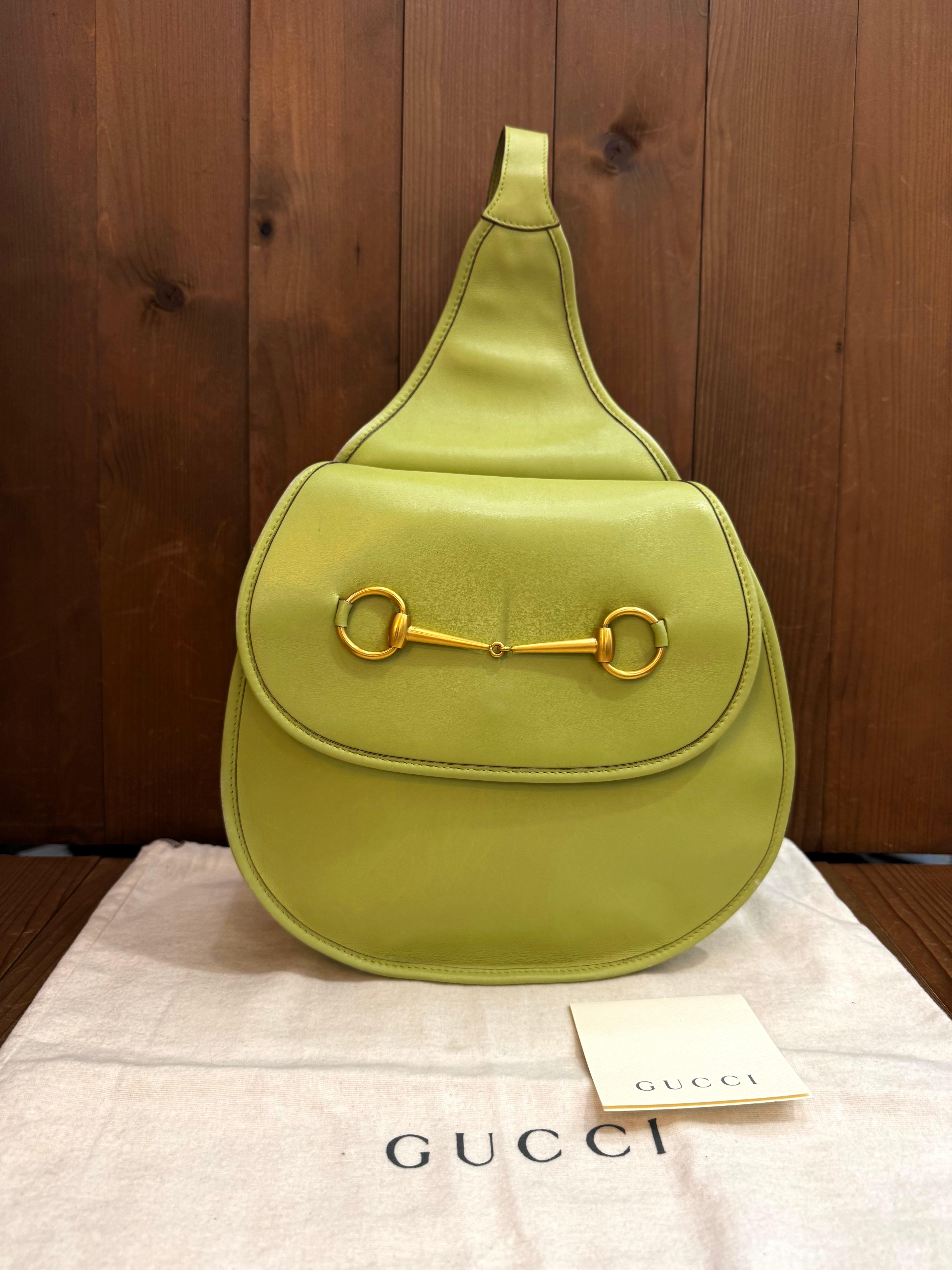 This vintage GUCCI large shoulder sling bag is crafted of smooth calfskin leather in green featuring a massive gold toned horse-bit at the front. Front flap magnetic snap closure opens to a green dimante interior featuring a zippered pocket.