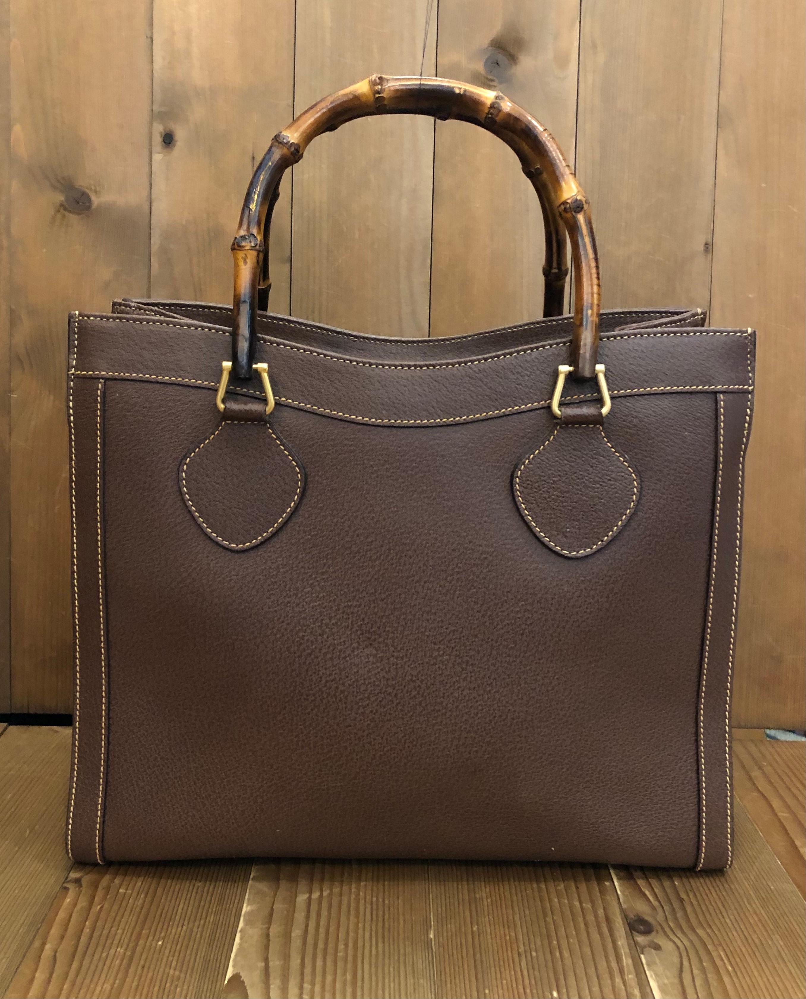 This vintage GUCCI Diana bamboo tote is crafted of pigskin’s leather in dark brown and matt gold toned hardware. Top magnetic snap closure opens to a new interior. It features two main compartments/one zip compartment and one interior zippered