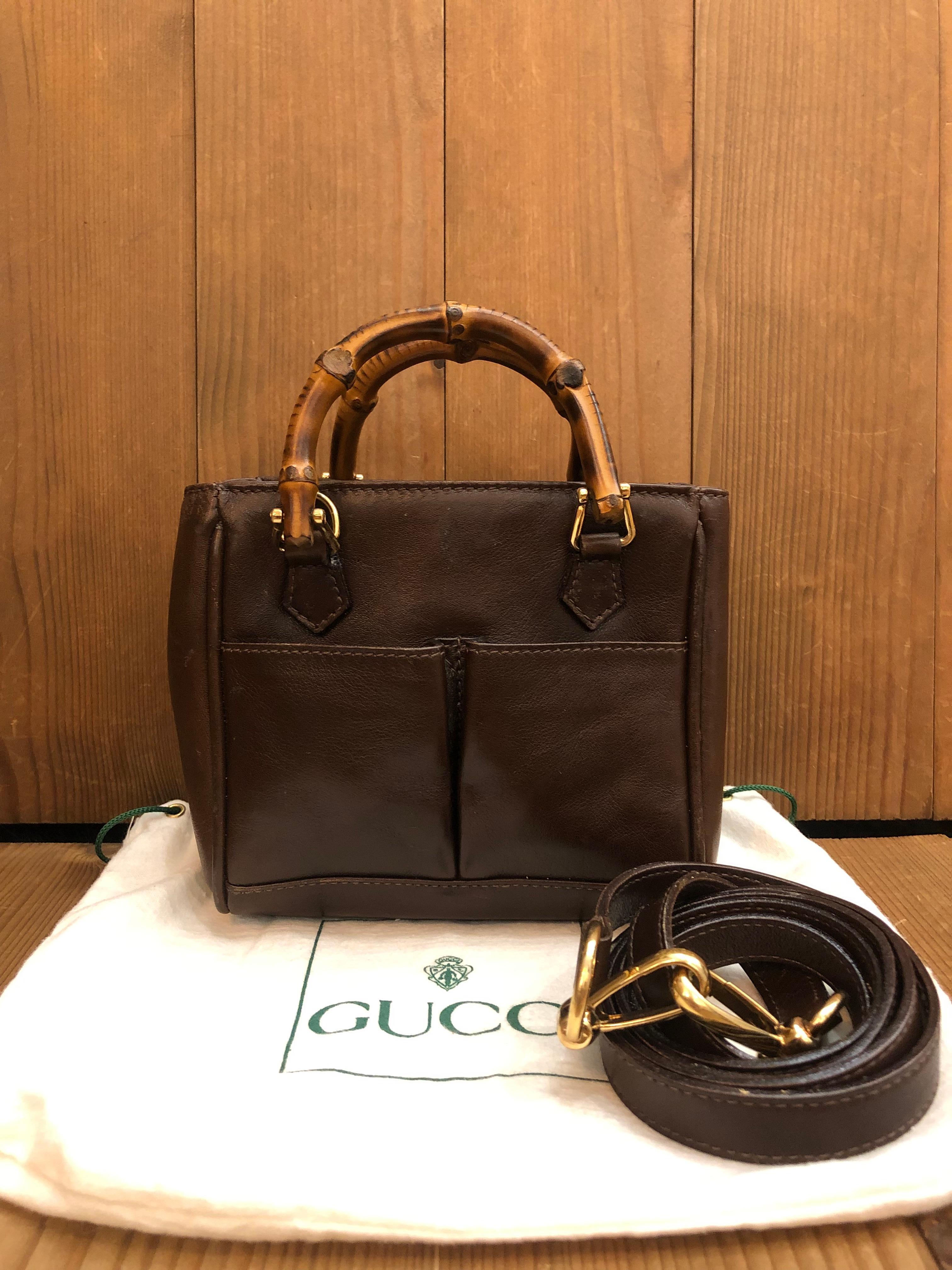 This 1990s vintage GUCCI mini 2-way bamboo crossbody bag is crafted of smooth calfskin leather in chocolate brown featuring gold toned hardware and bamboo handles. The front of this bag features two open pockets (professionally cleaned). Top