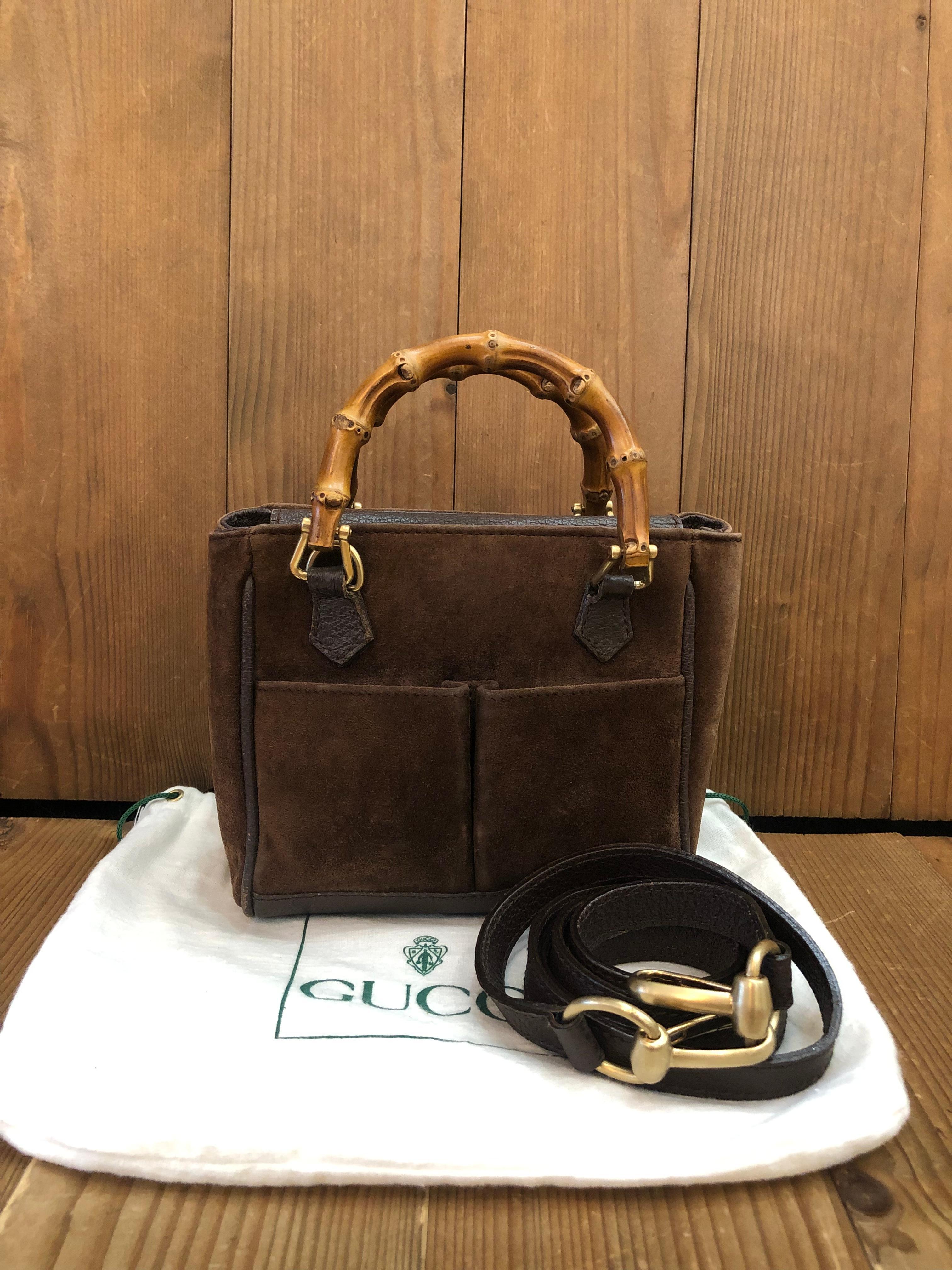 This 1990s vintage GUCCI mini 2-way bamboo crossbody bag is crafted of pigskins and nubuck leather in chocolate brown featuring matt gold toned hardware and bamboo handles. The front of this bag features two open pockets lined with diamanté